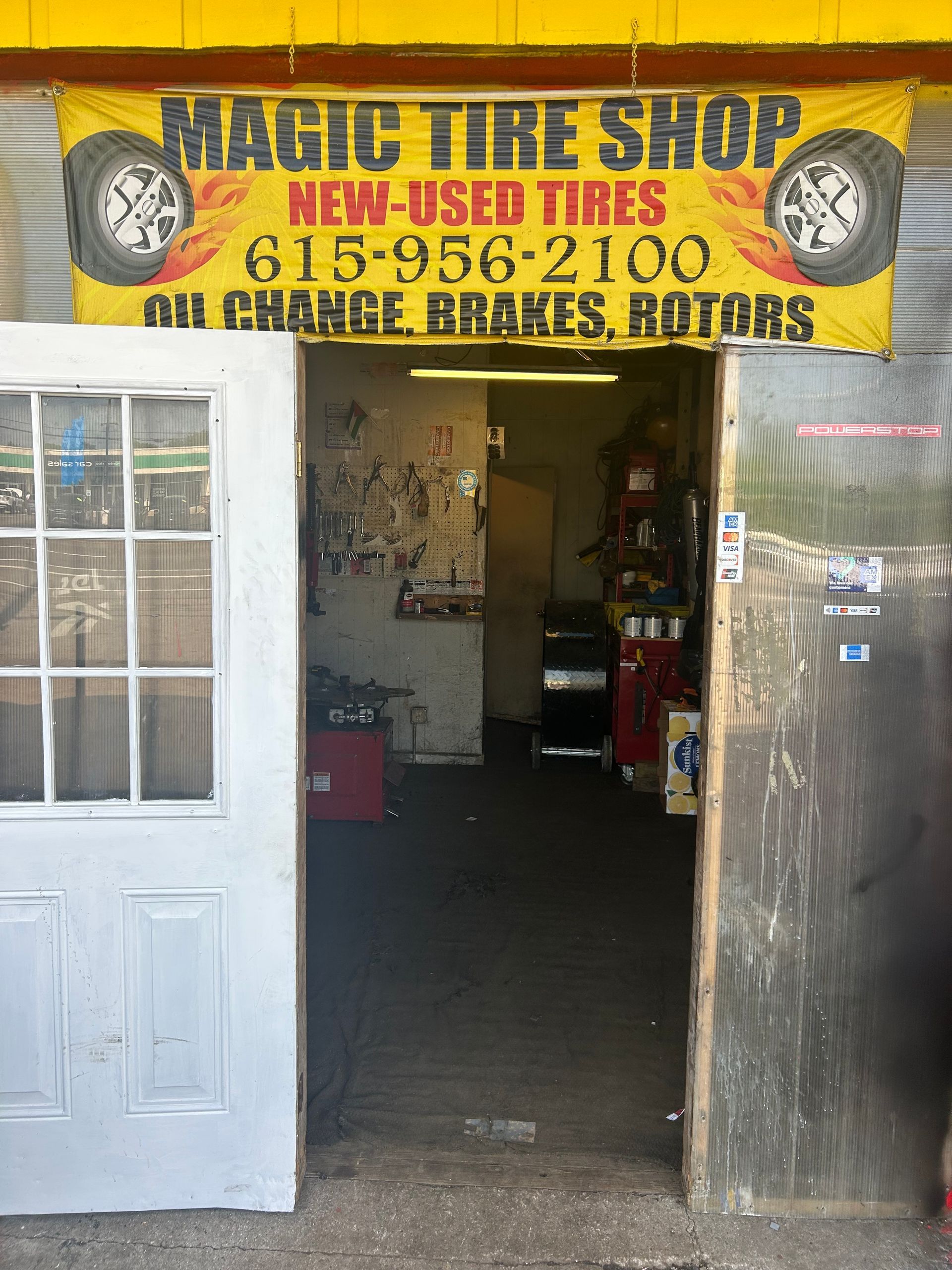 The inside of a tire shop with a sign that says magic tire shop