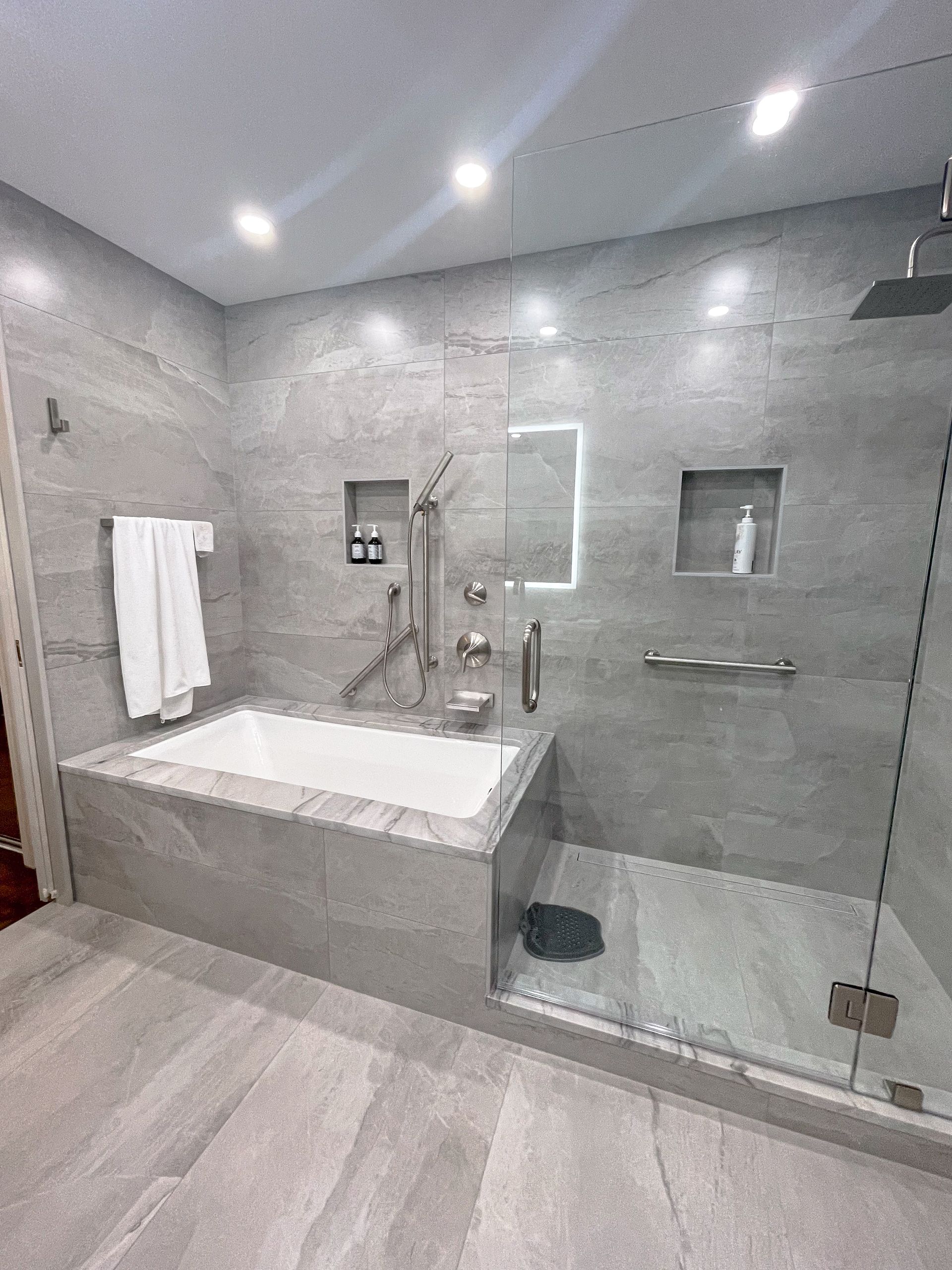 A bathroom with a bathtub and a walk in shower.