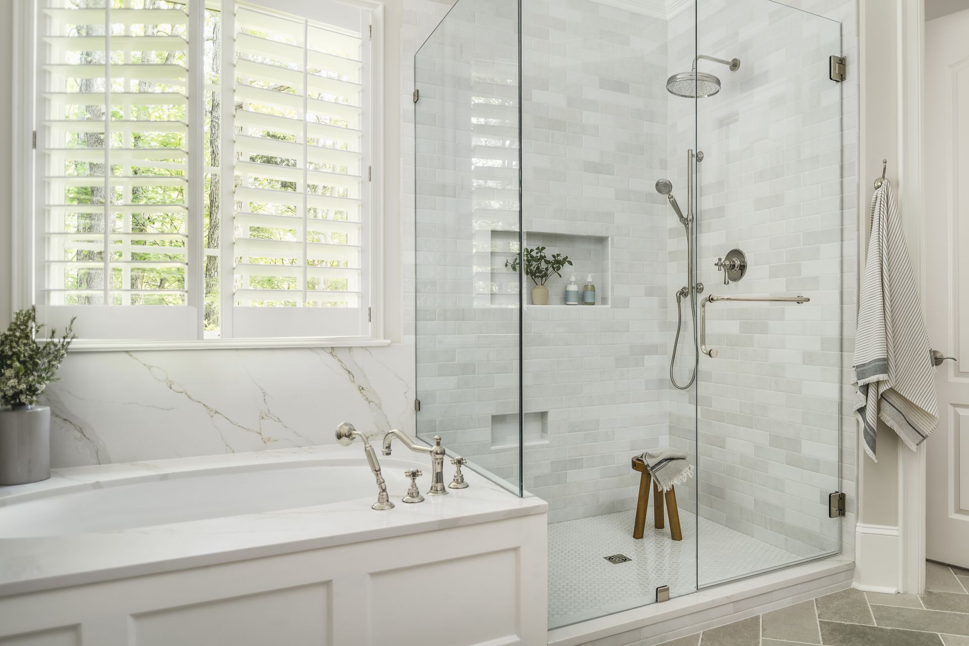 A bathroom with a walk in shower and a bathtub.