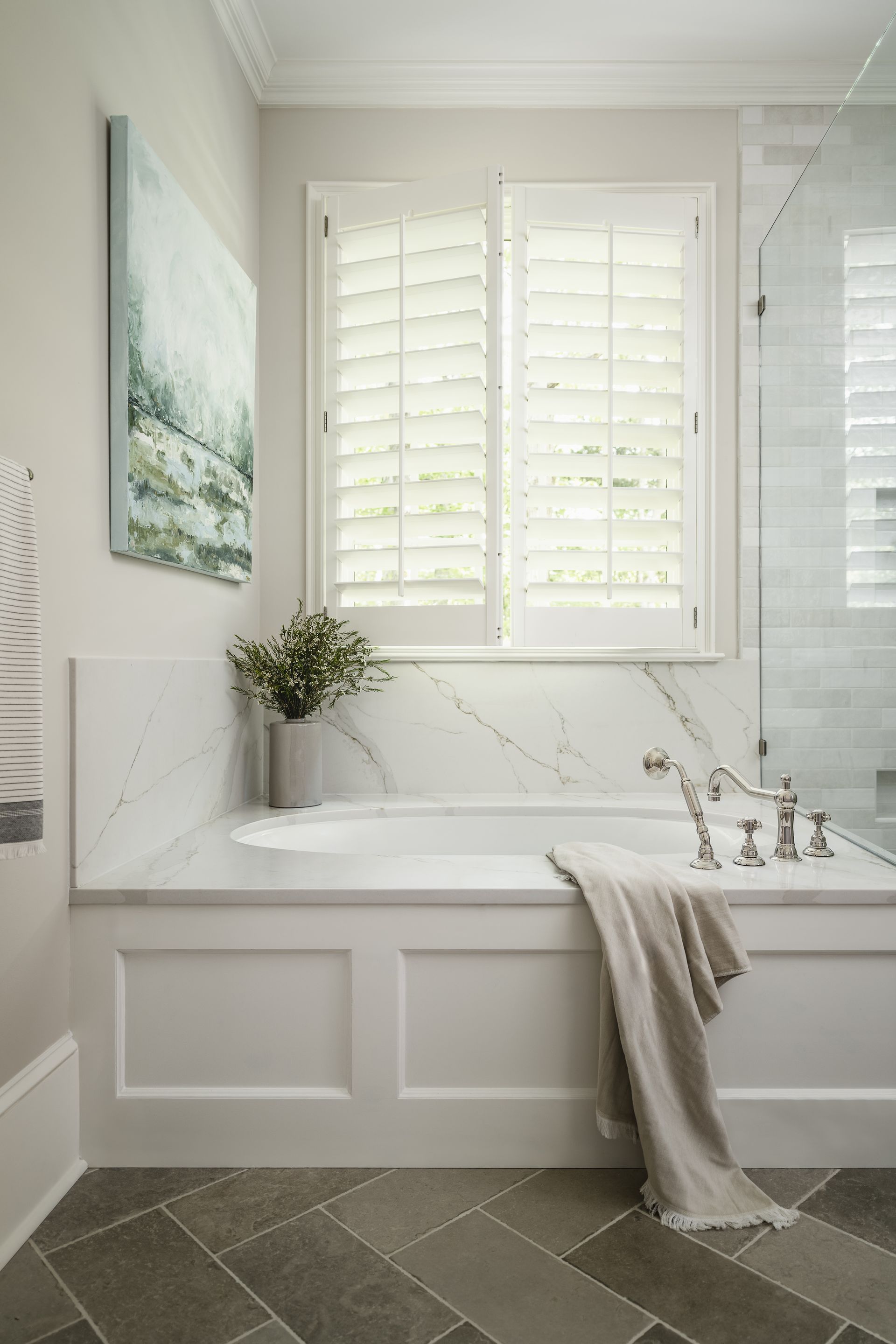 A bathroom with a bathtub and a window.