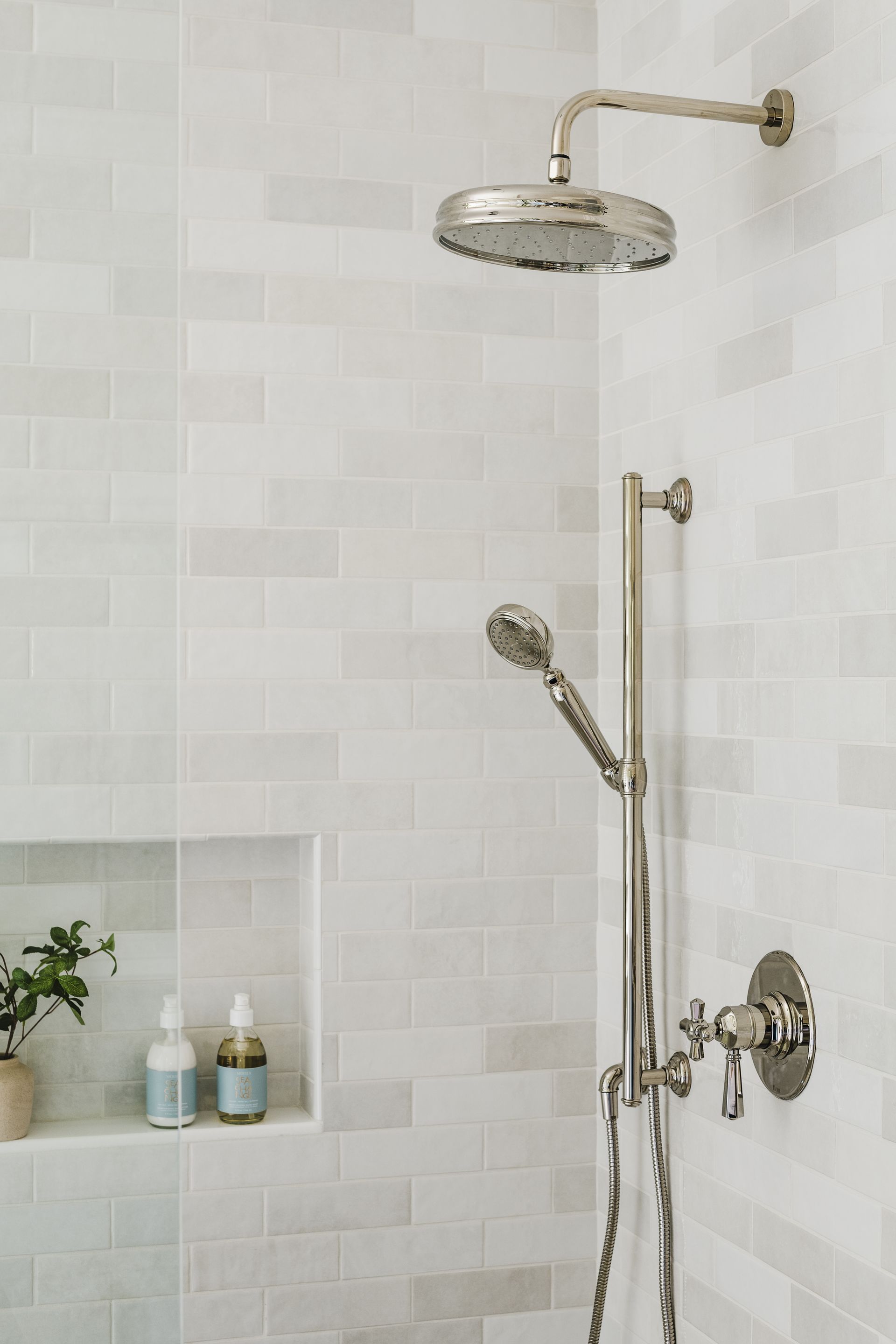A shower head is hanging from the wall in a bathroom.