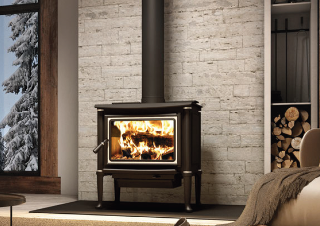 Black wood stove with fire burning in a cozy brick-walled room