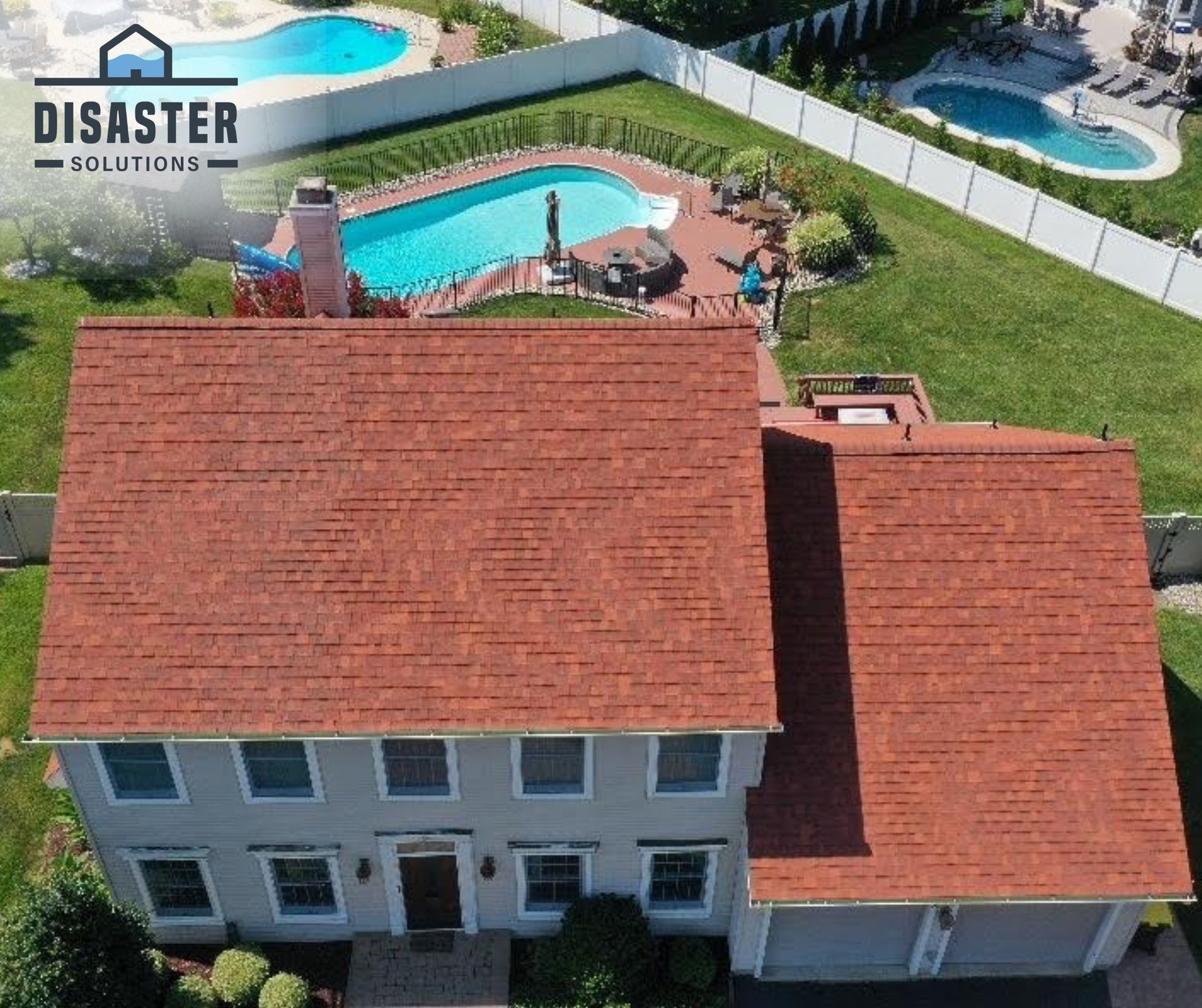 Overhead view of a house with a red roof, a swimming pool, and Disaster Solutions logo.