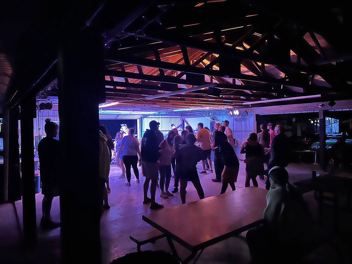 People dancing with purple and blue lights