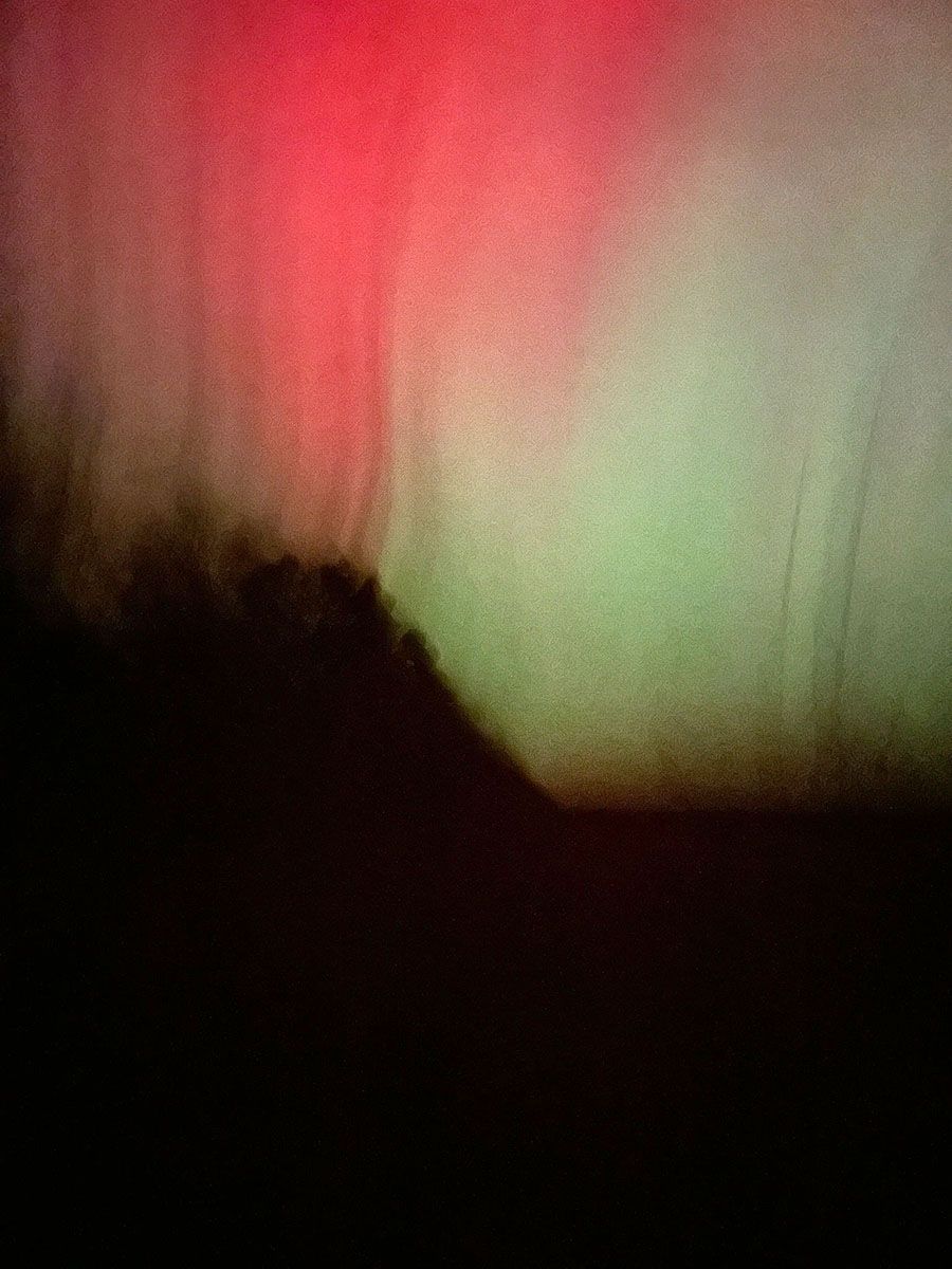 Aurora borealis above a dark landscape