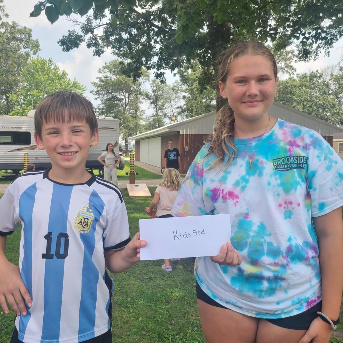 Two kids holding a paper
