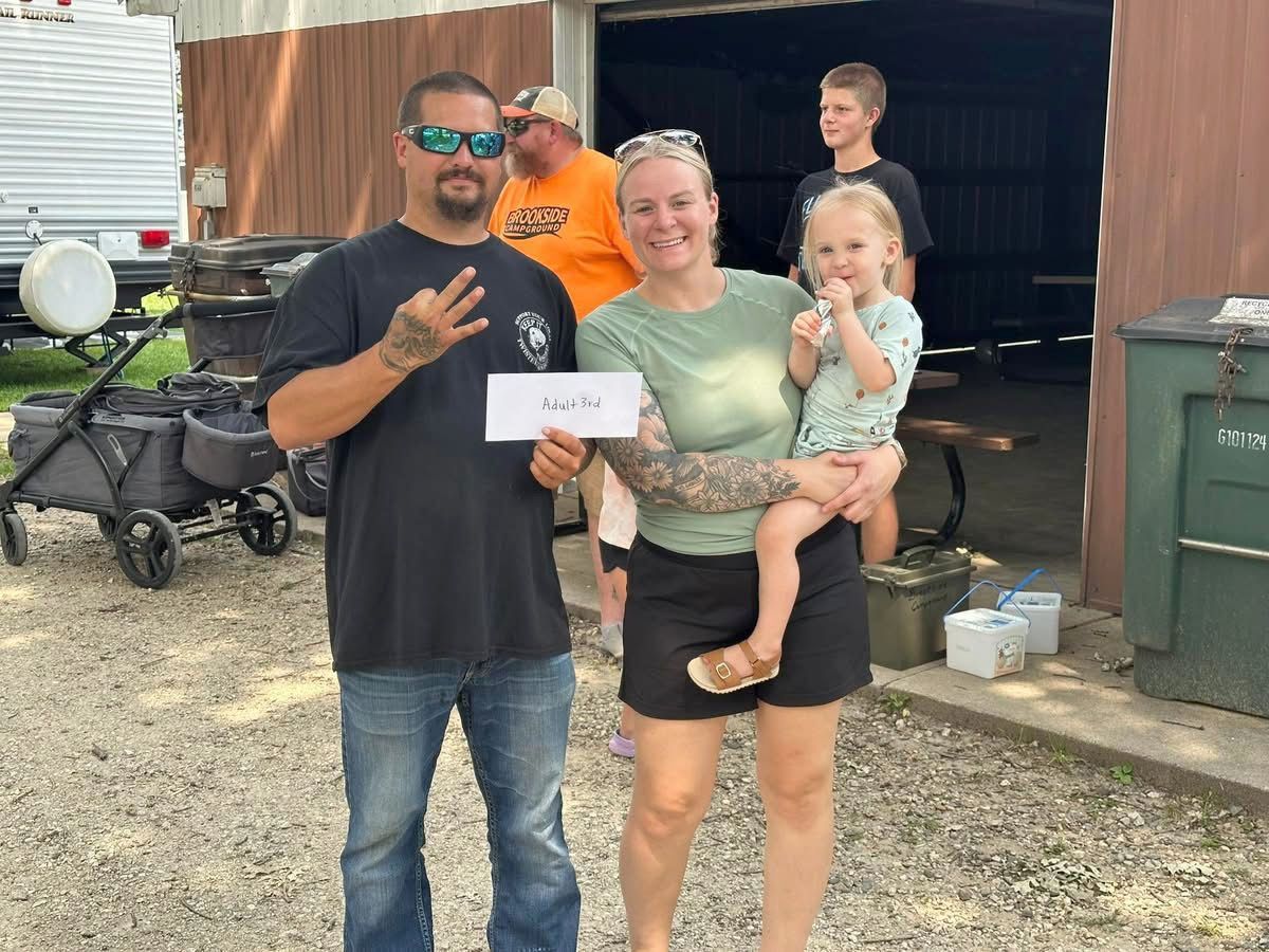 Family holding their prize outdoors