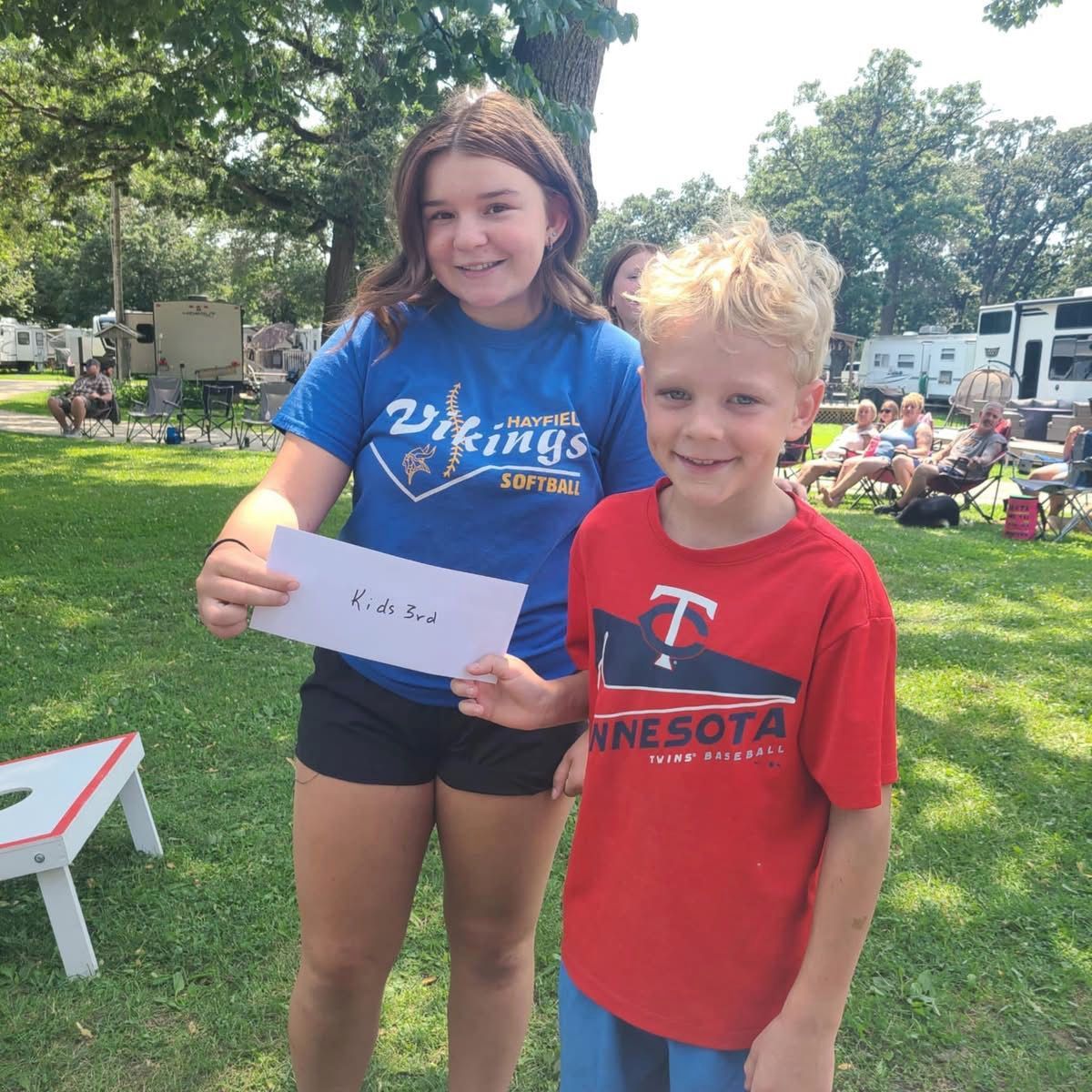 Two kids holding their prize