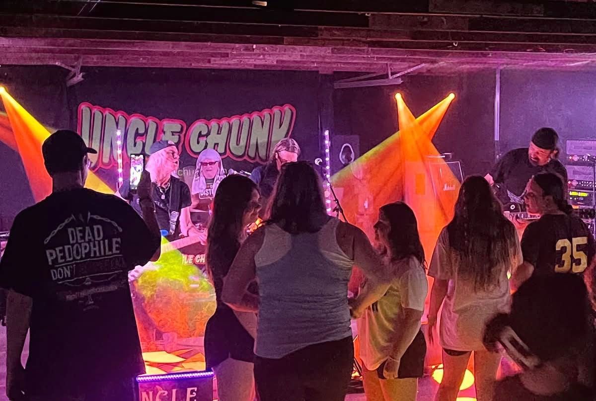 A band performing onstage with a crowd