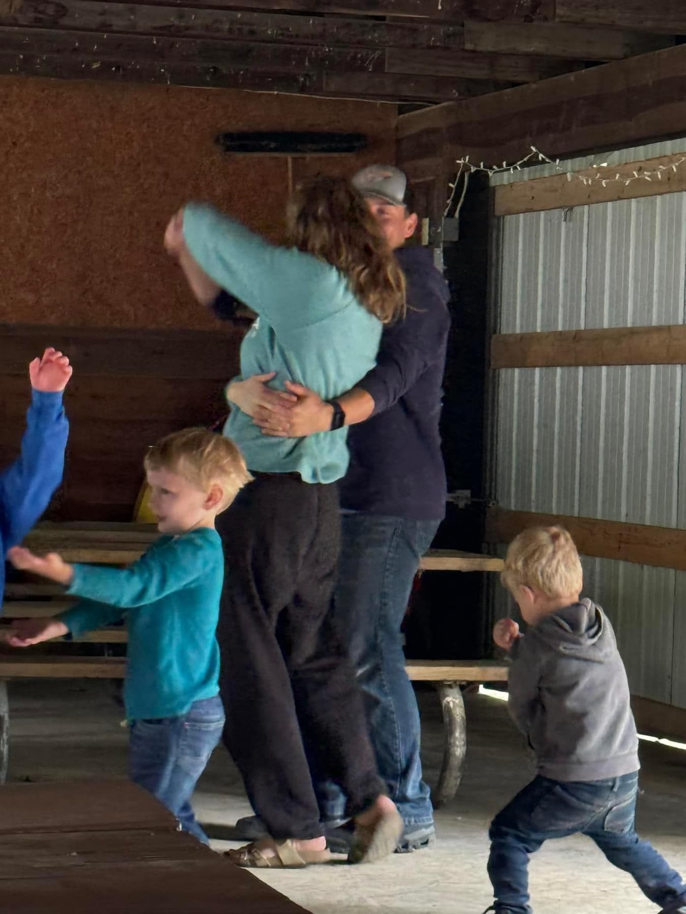 A group of people are dancing in a room.