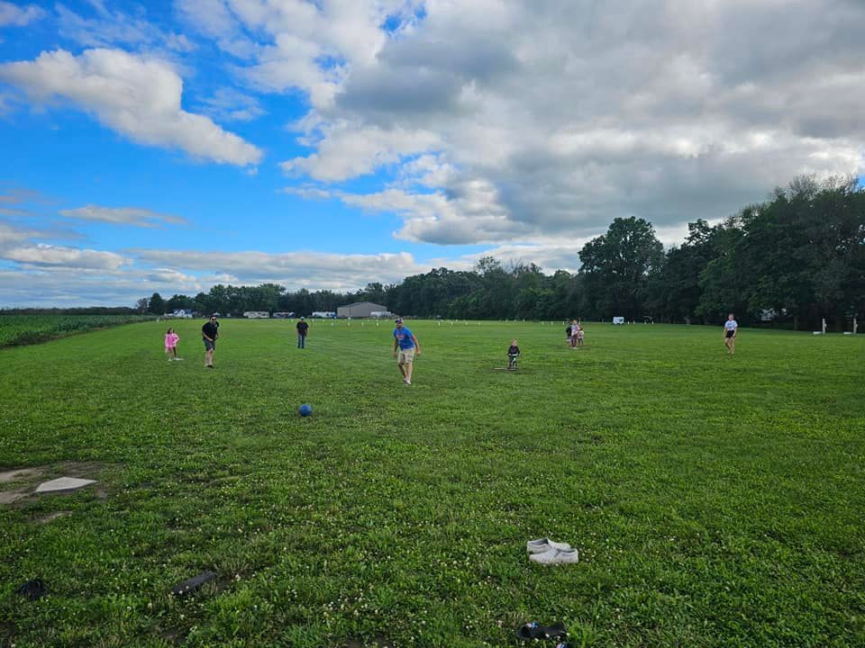 A group of people are playing frisbee in a grassy field.