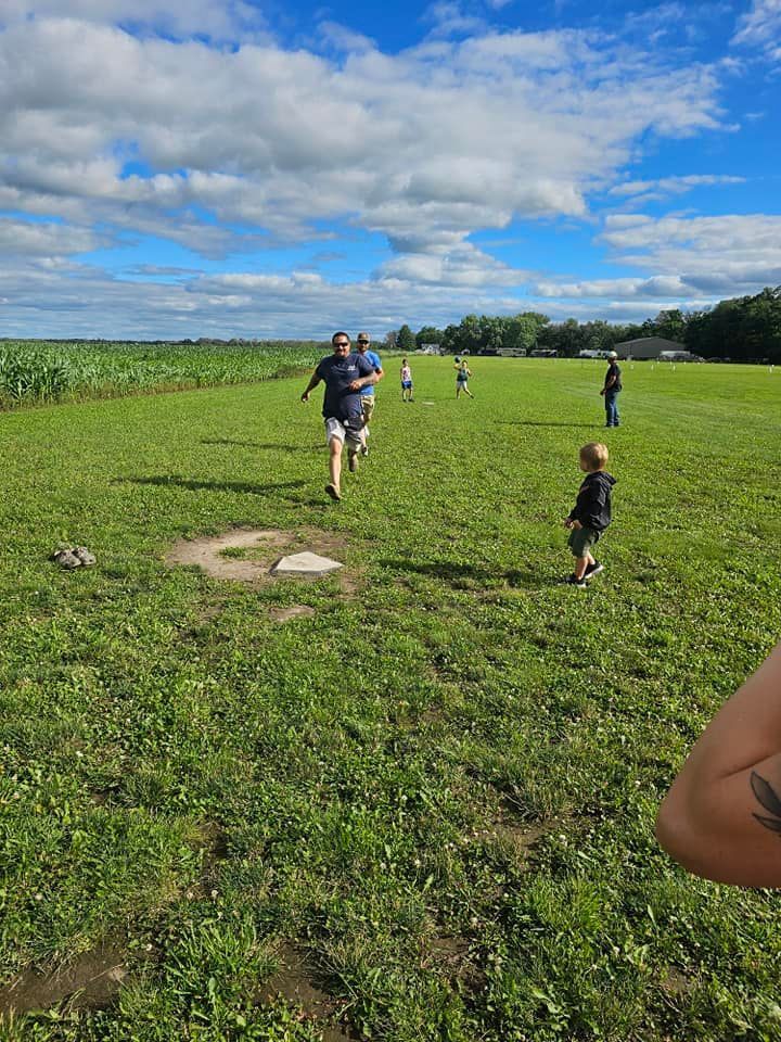A group of people are playing baseball in a field.