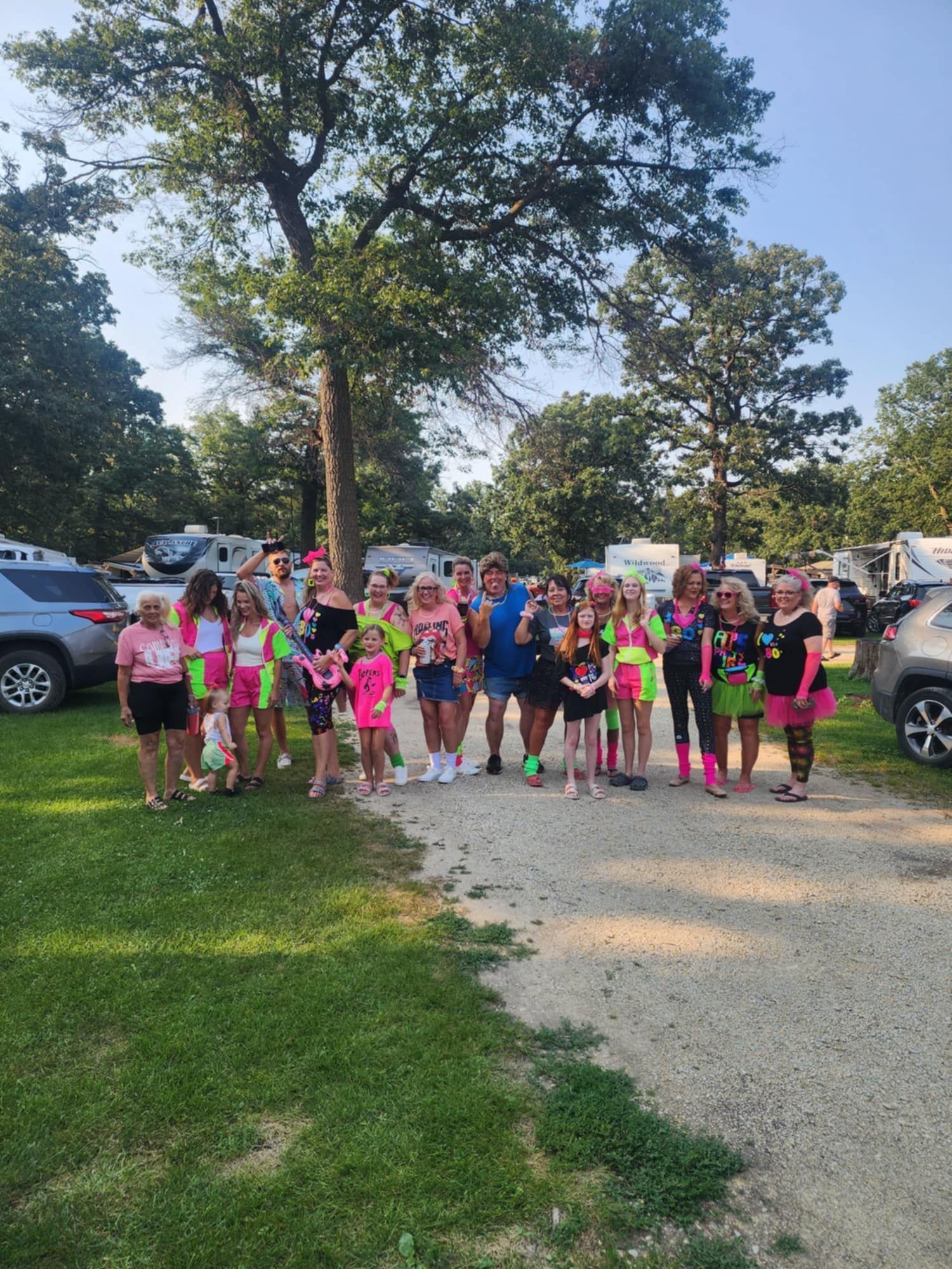 A group of people are posing for a picture in a park.