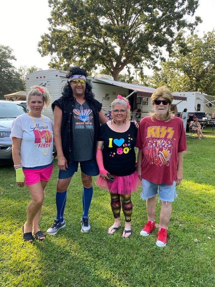 A group of people are posing for a picture in a park.