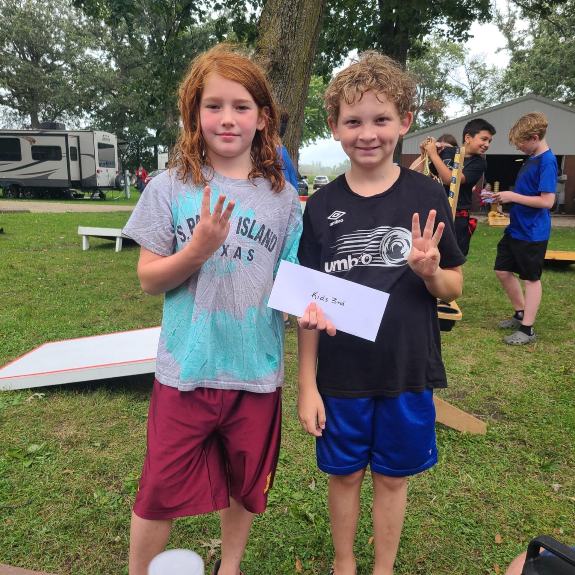 A boy and a girl are posing for a picture.
