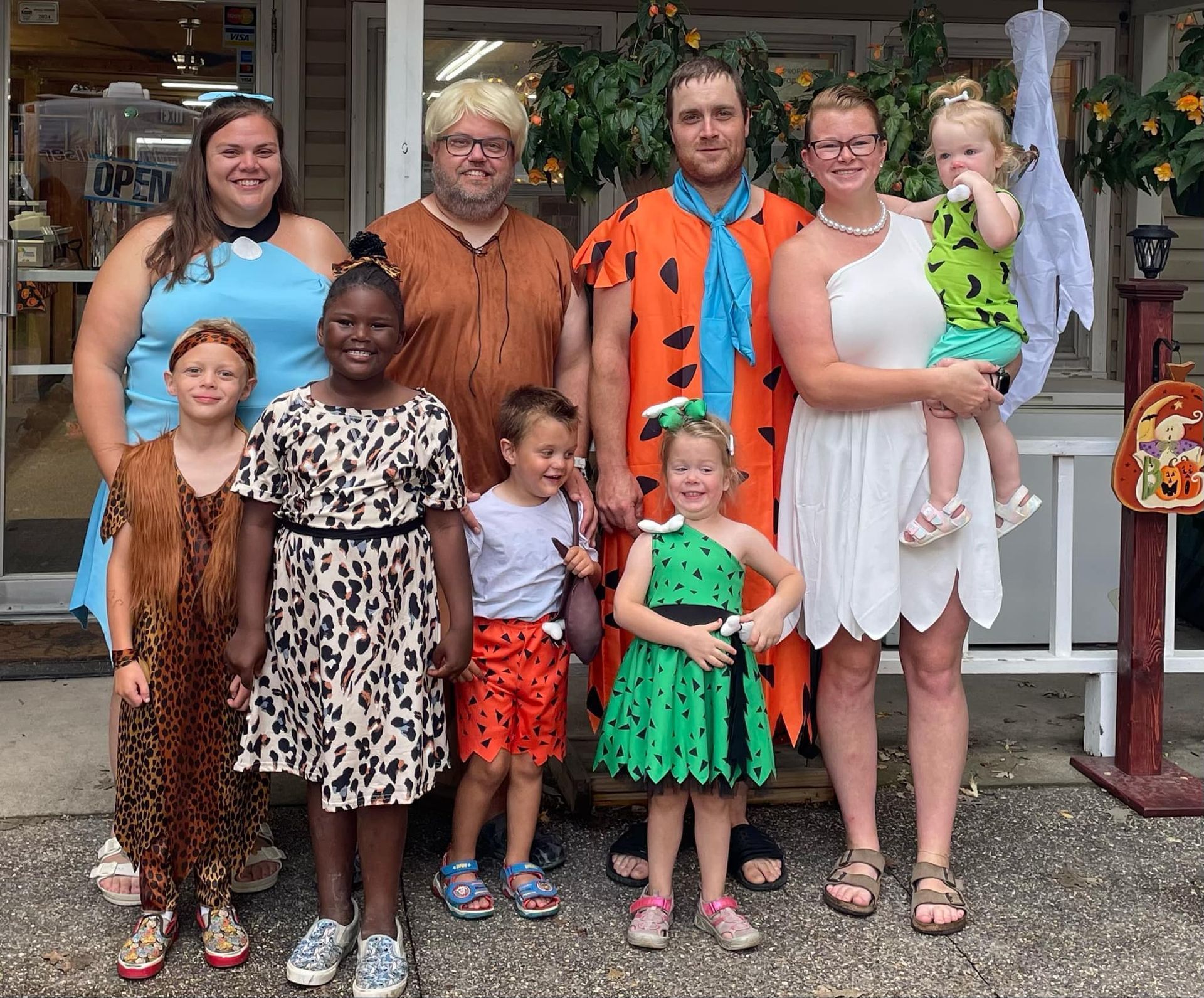A group of people dressed in costumes are posing for a picture.