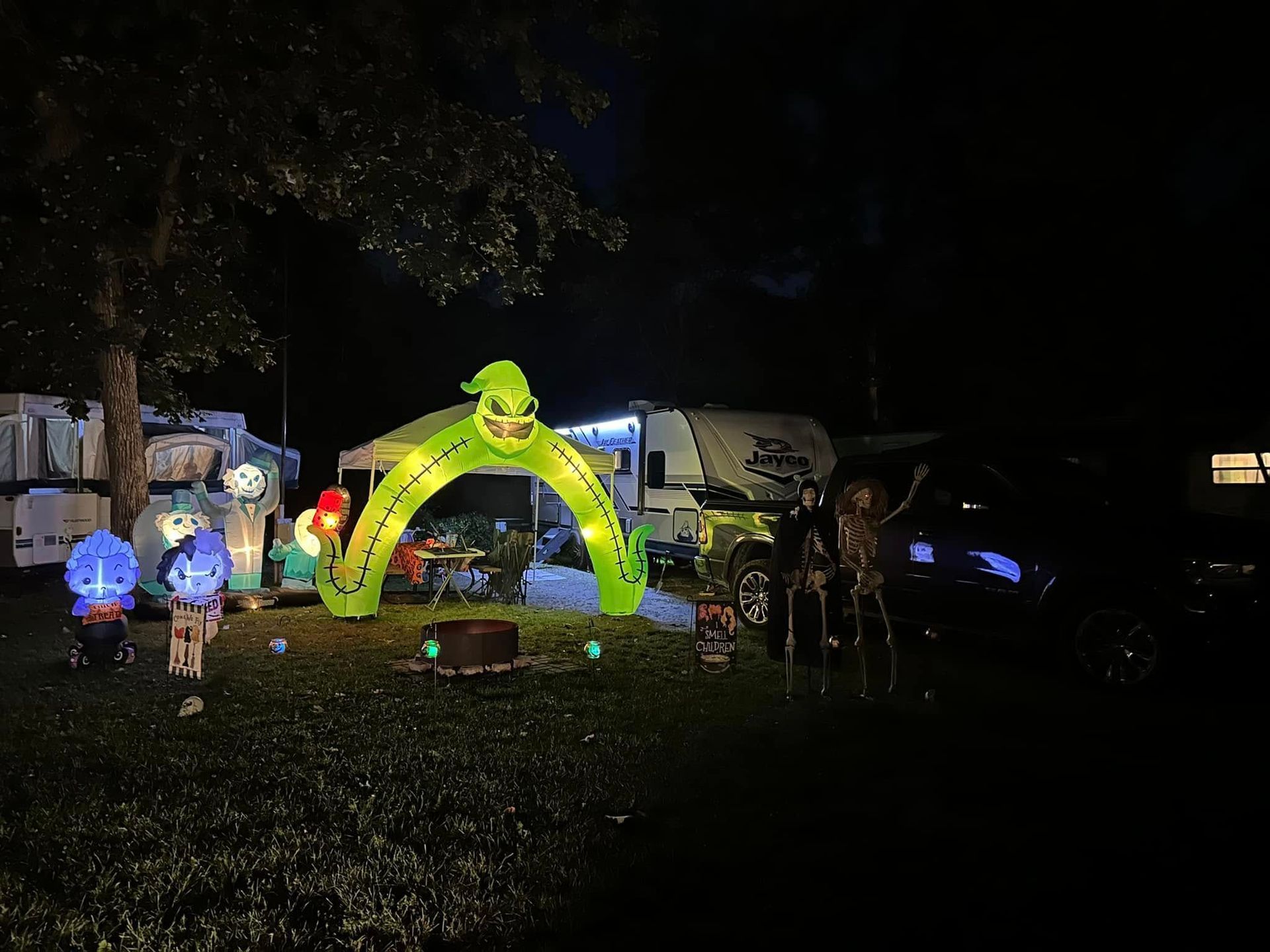A campground decorated for Halloween with an RV in the background.