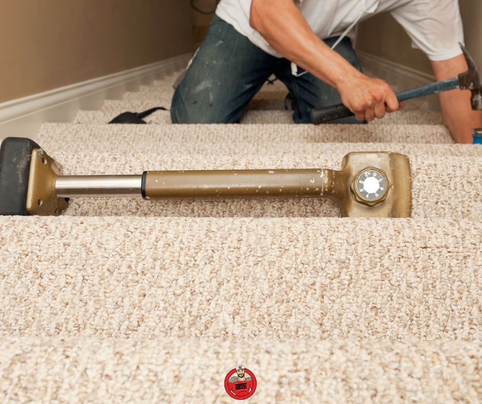 Person installing beige carpet on stairs with a knee kicker and hammer.