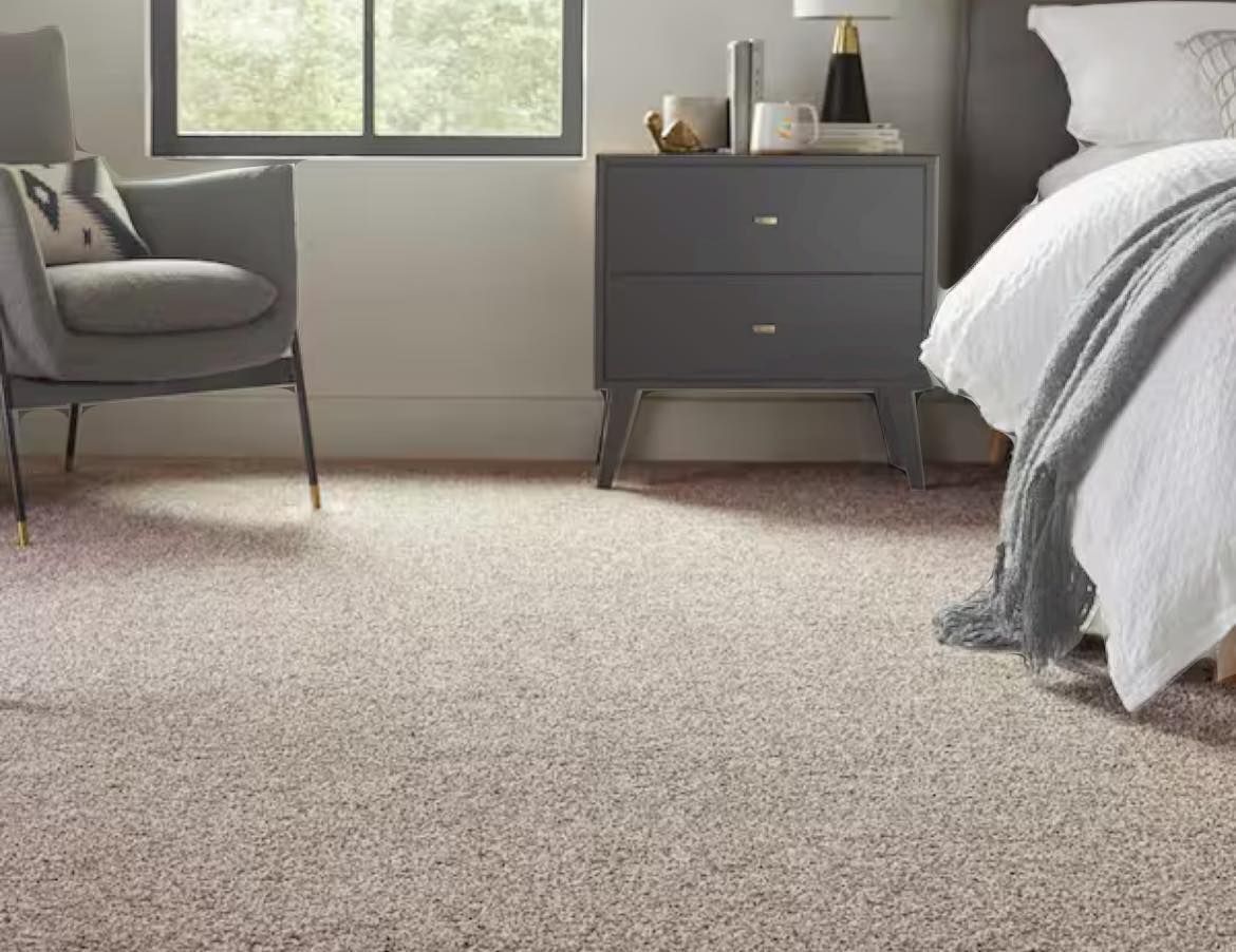 Bedroom with gray furniture, neutral carpet, and a window.