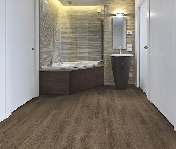 Bathroom with dark wood-look floor, a bathtub, dark vanity, and neutral-colored tile walls.