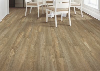 Wood-look flooring in a dining area with white chairs and a table.