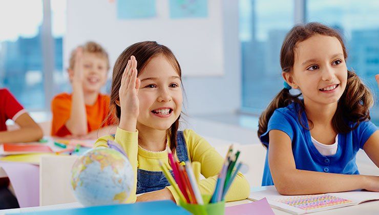 little girl raising her hand