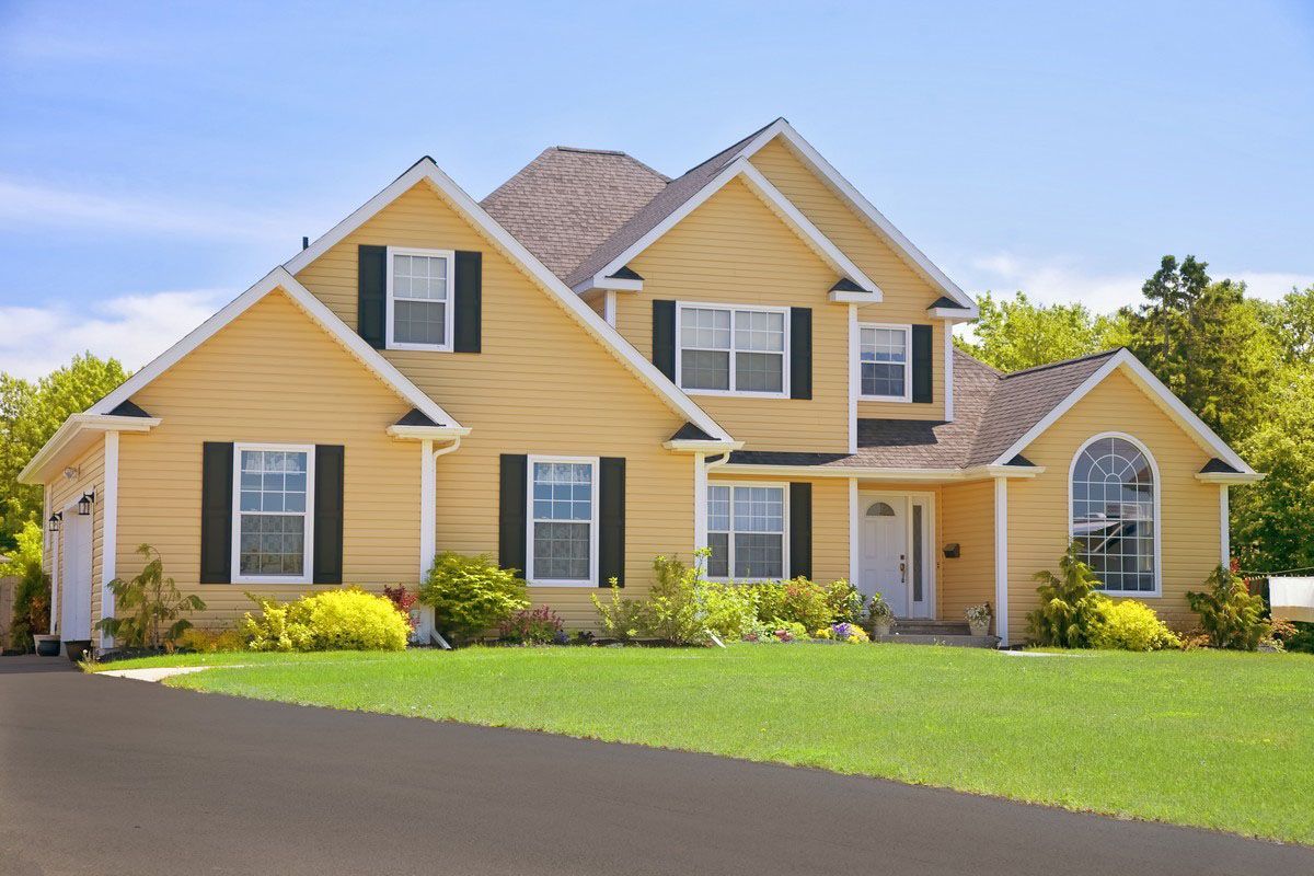 The roof of a house with a blue sky in the background.
