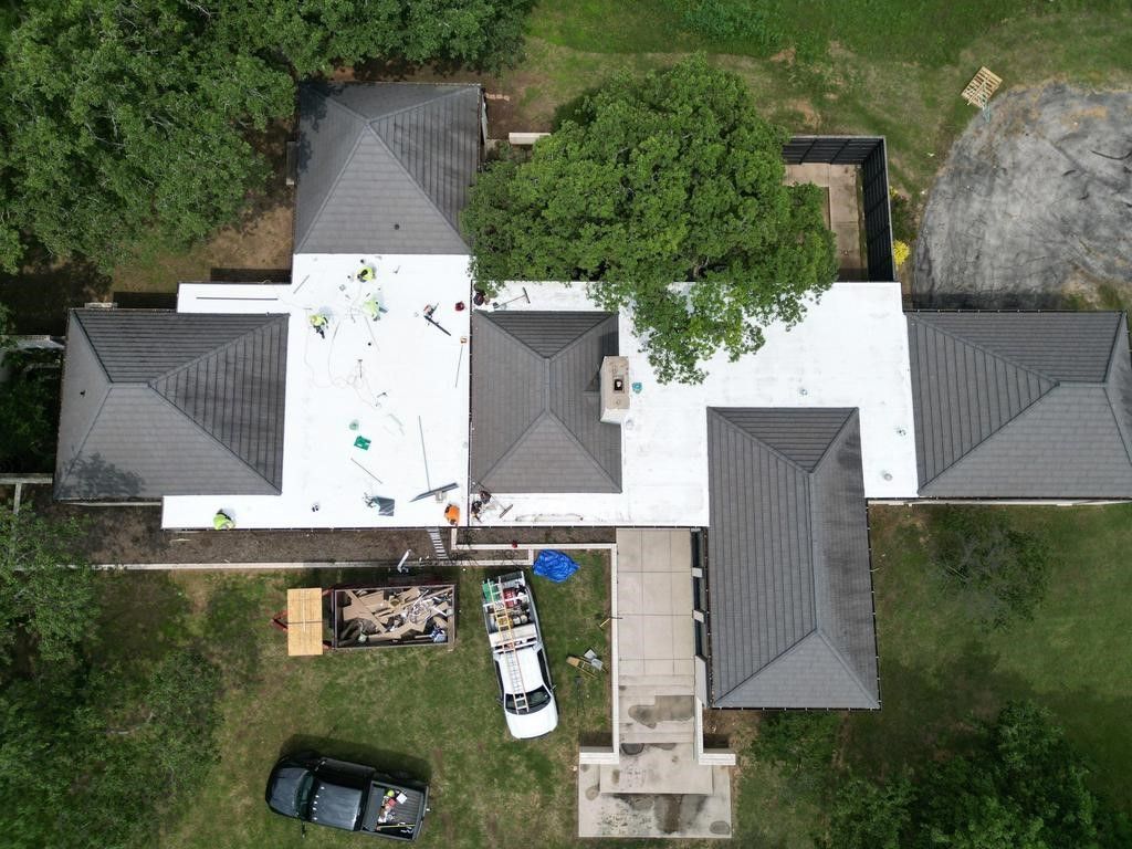 An aerial view of a house with a truck parked in front of it.