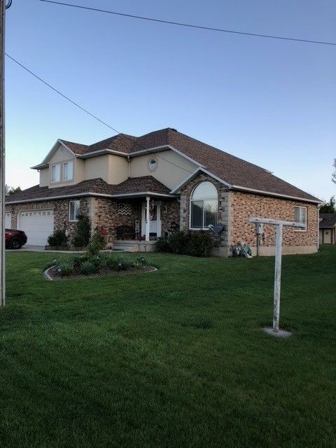 A large house with a basketball hoop in front of it