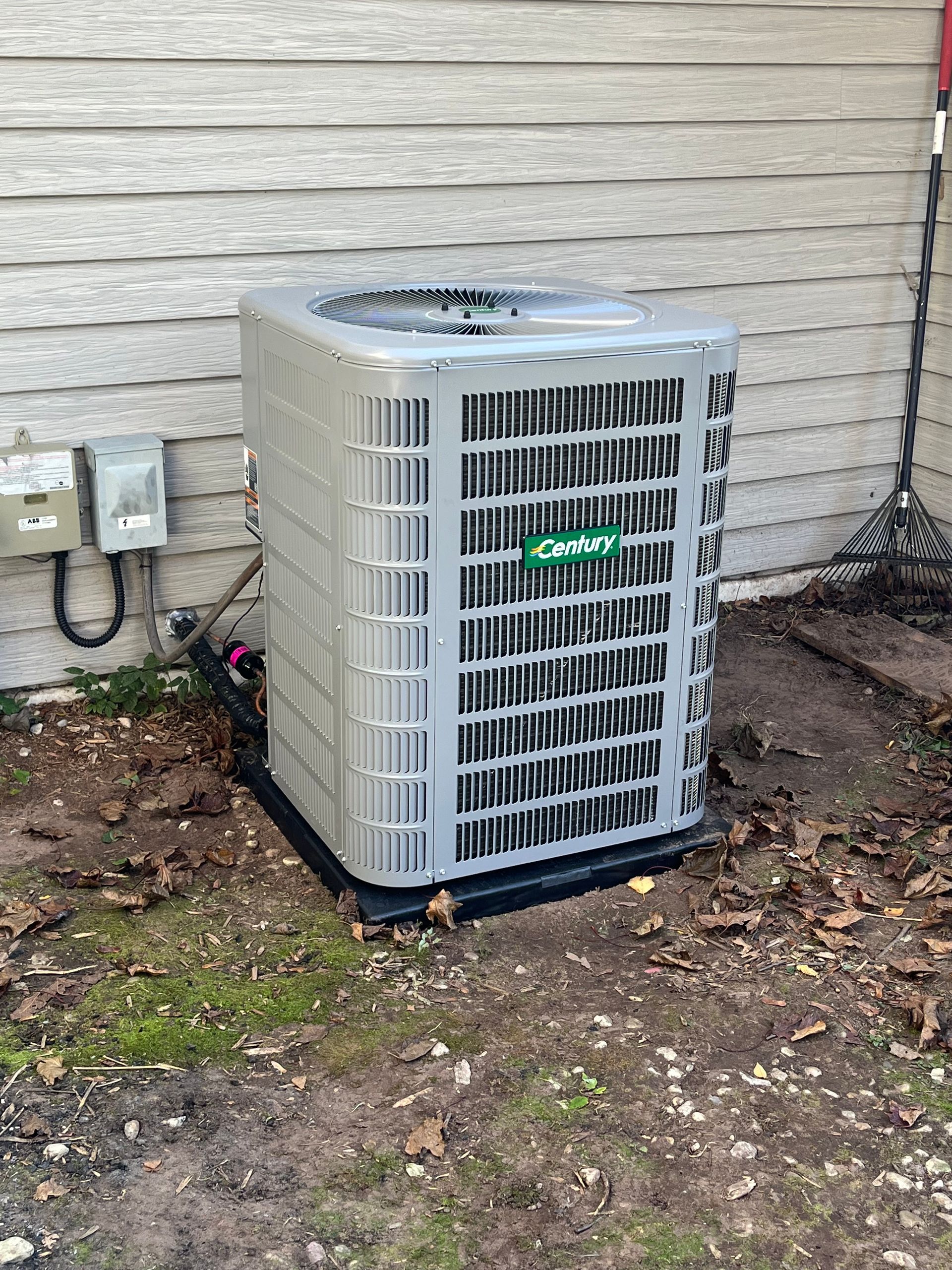 An air conditioner is sitting outside of a house.