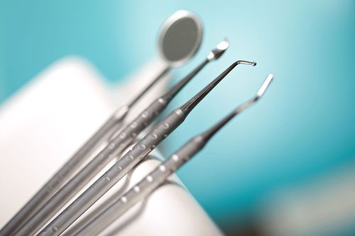 Dental tools on a white cloth with a blue background
