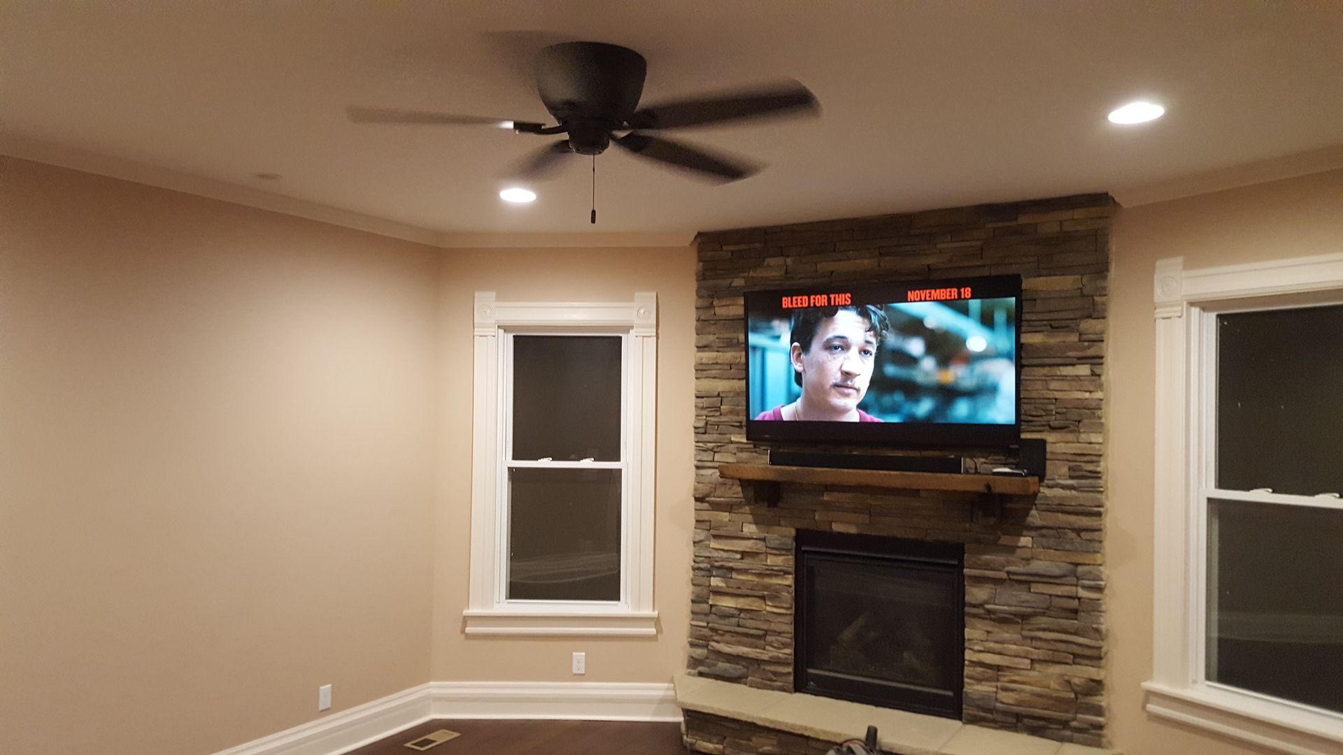 A living room with a fireplace and a flat screen tv.
