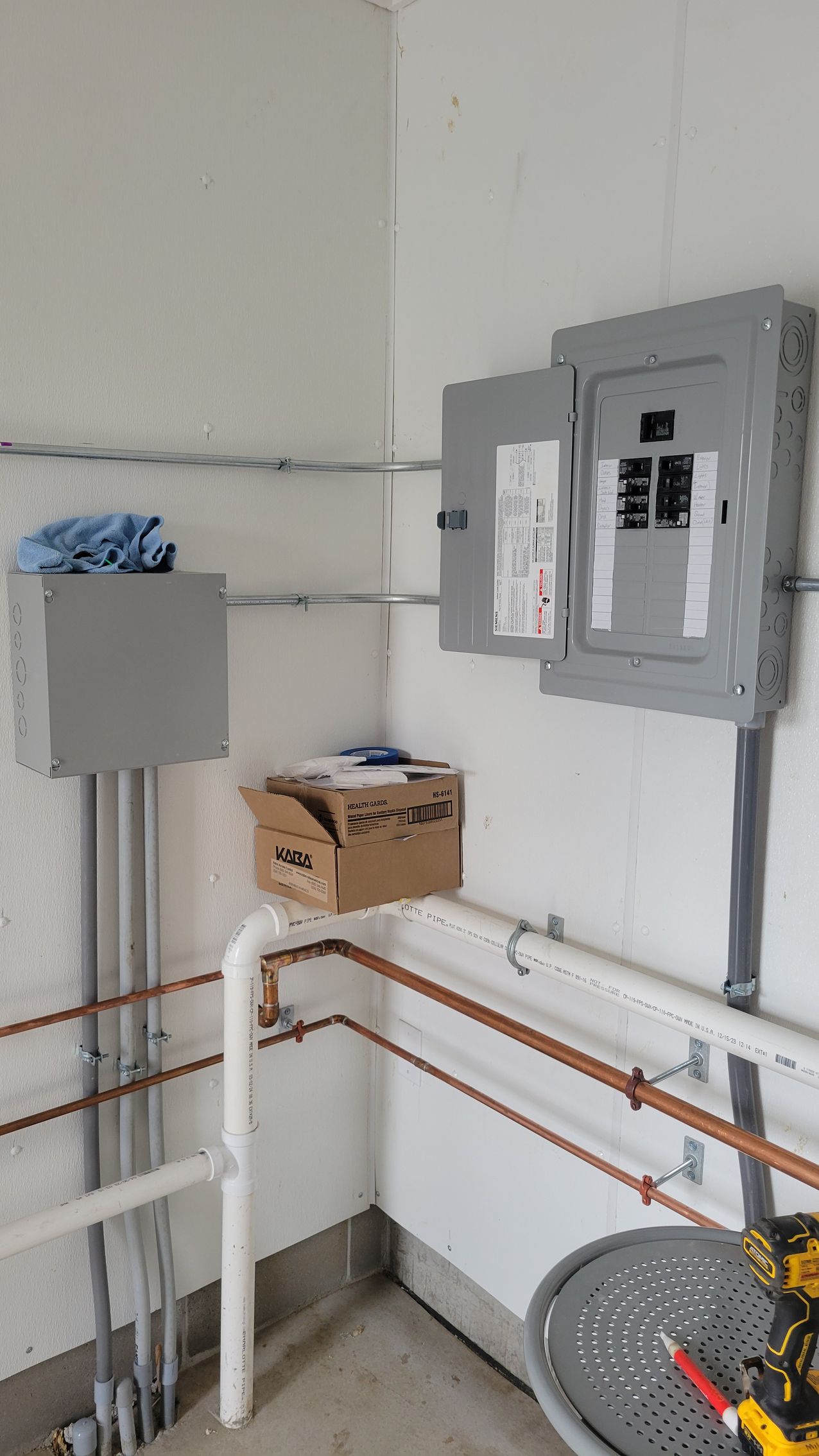 There is a box on the wall next to the electrical box.