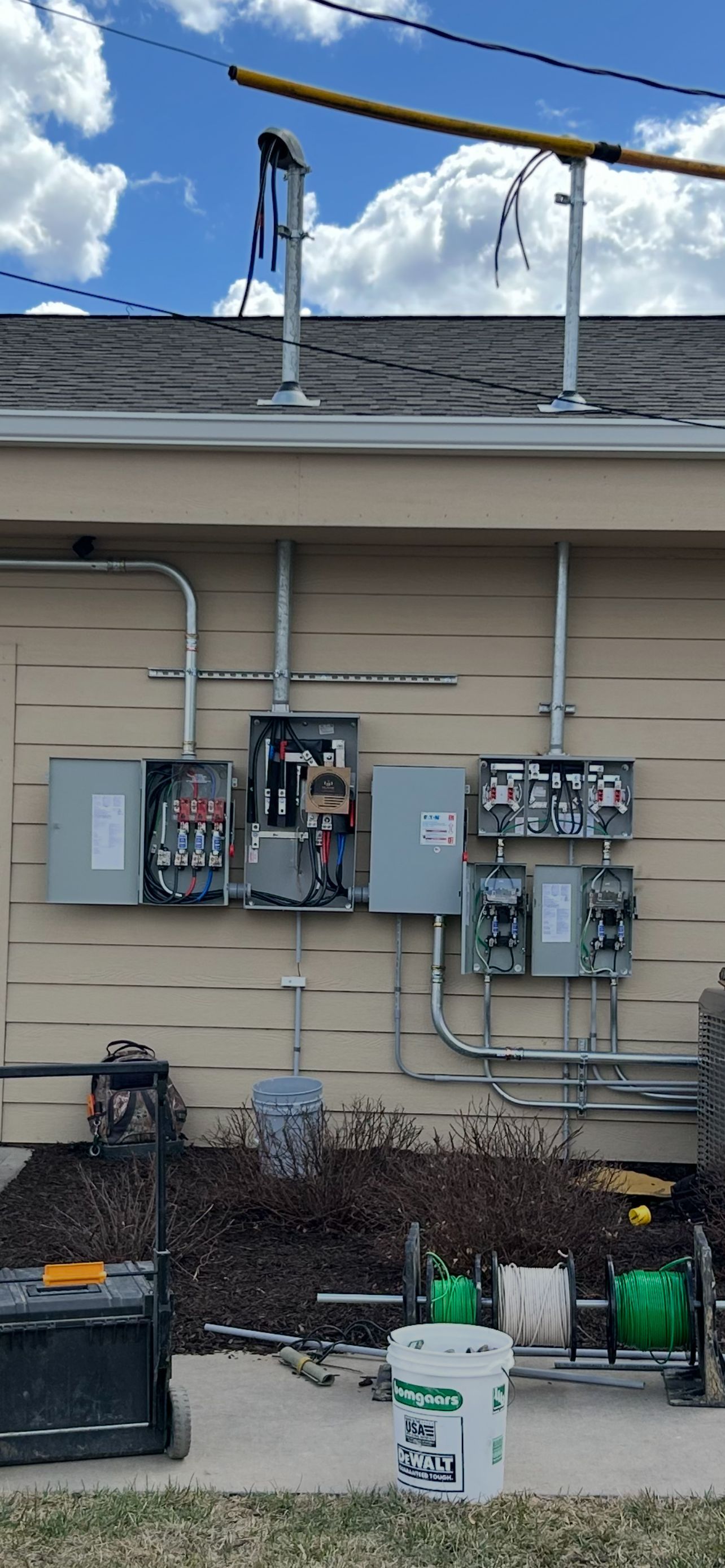 A house with a lot of electrical boxes on the side of it.