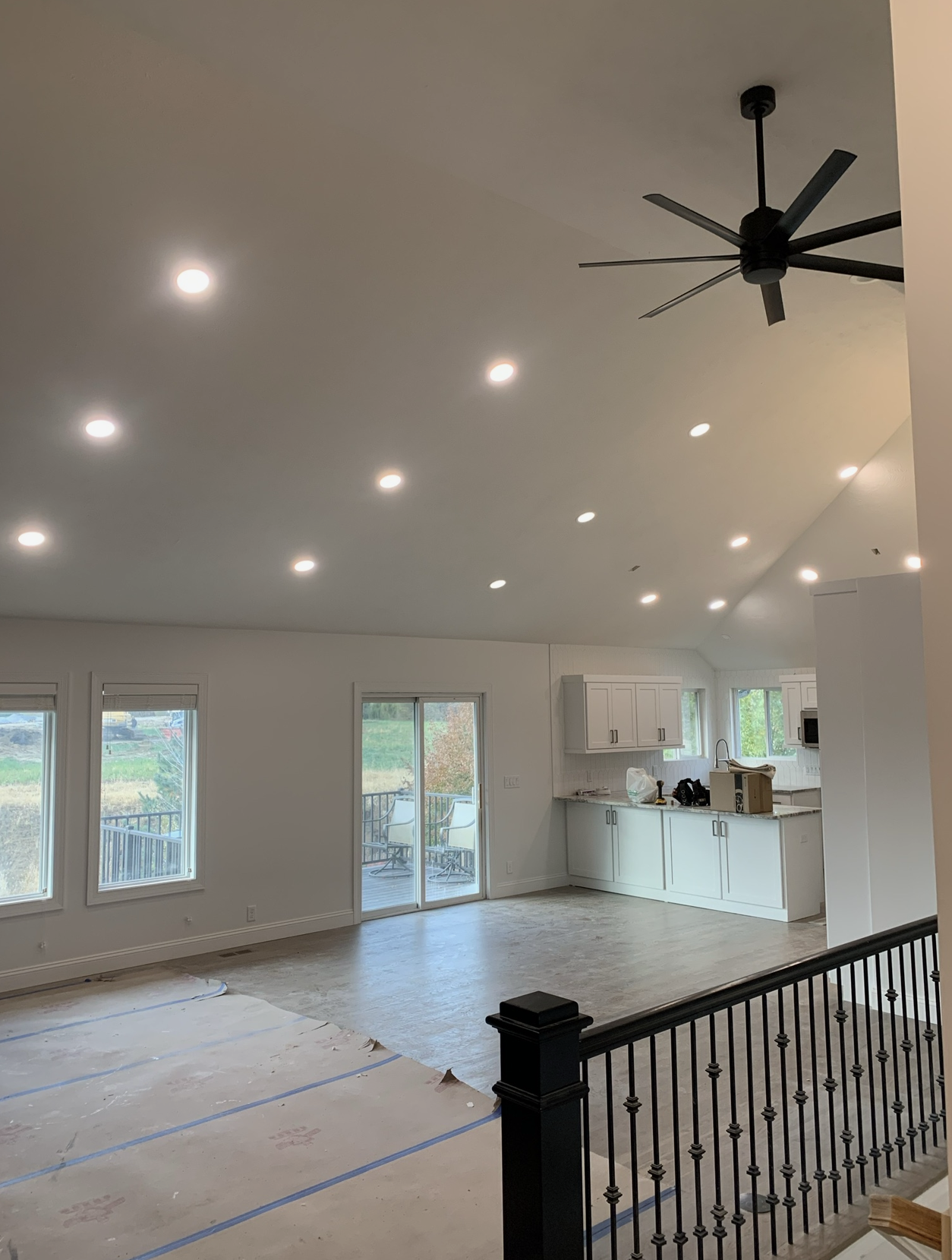 There is a ceiling fan in the middle of the room.