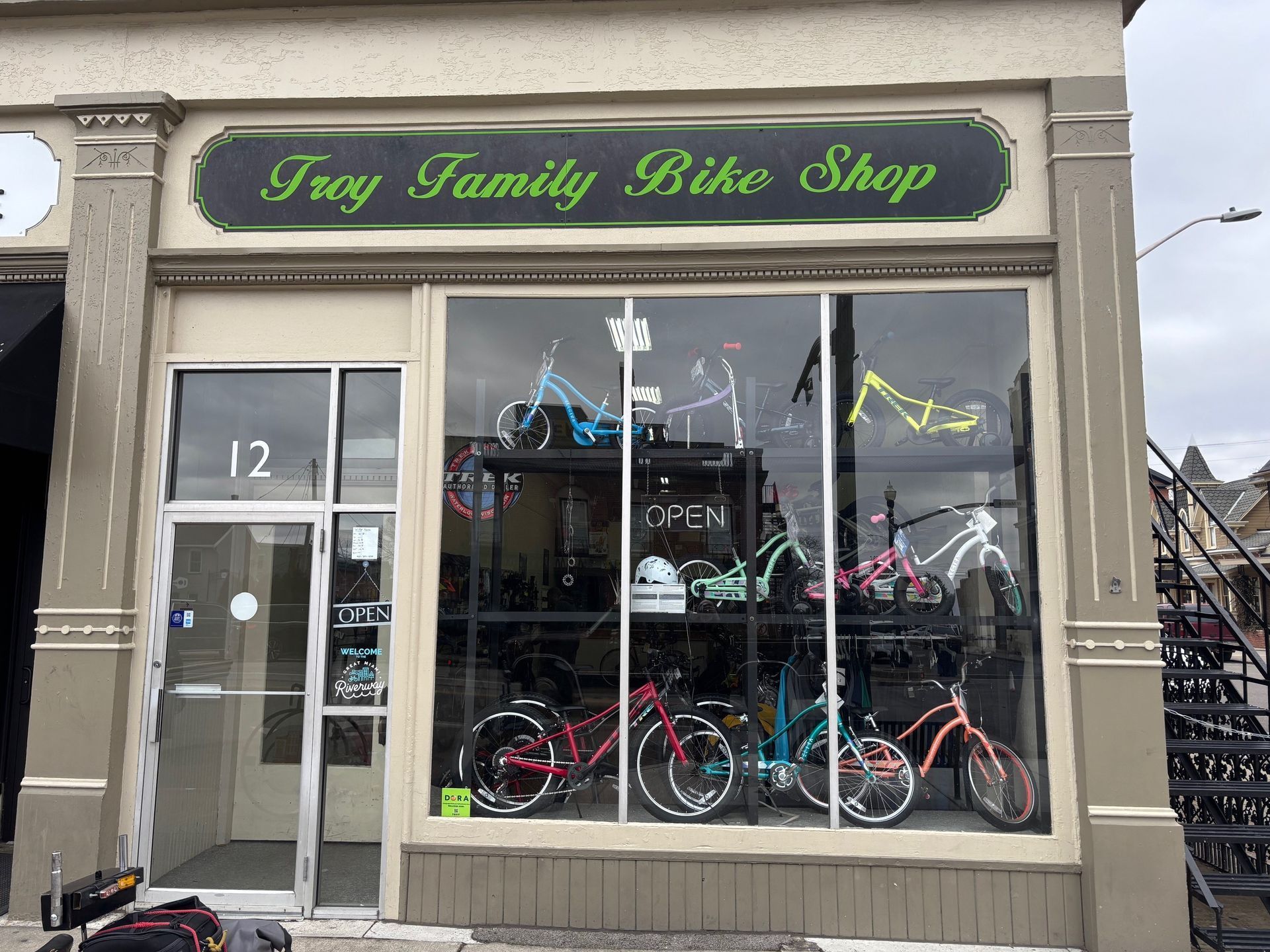 The front of the troy family bike shop with bicycles in the window.