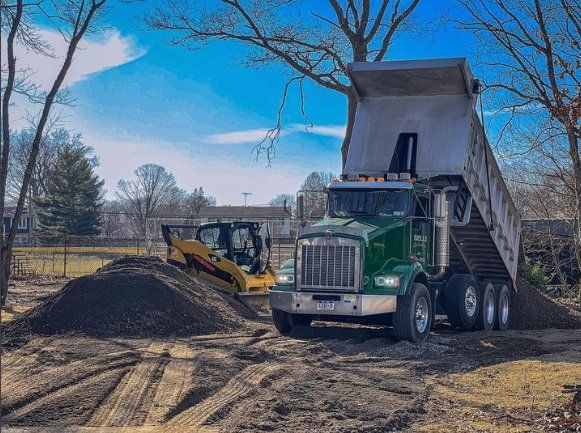 Dump truck unloading dirt