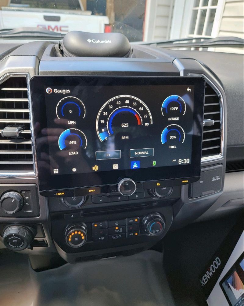Truck dashboard with large digital display showing gauges and controls.