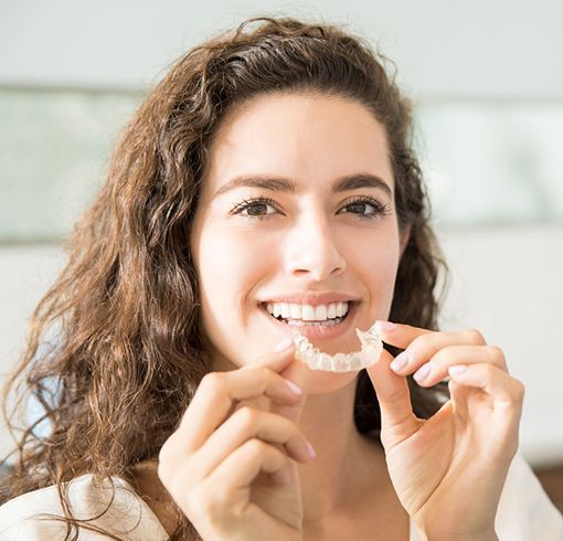 Woman holding orthodontic retainers