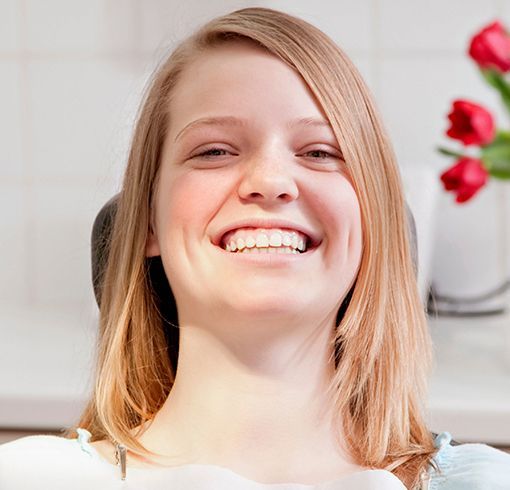 Smiling teenager in dental chair