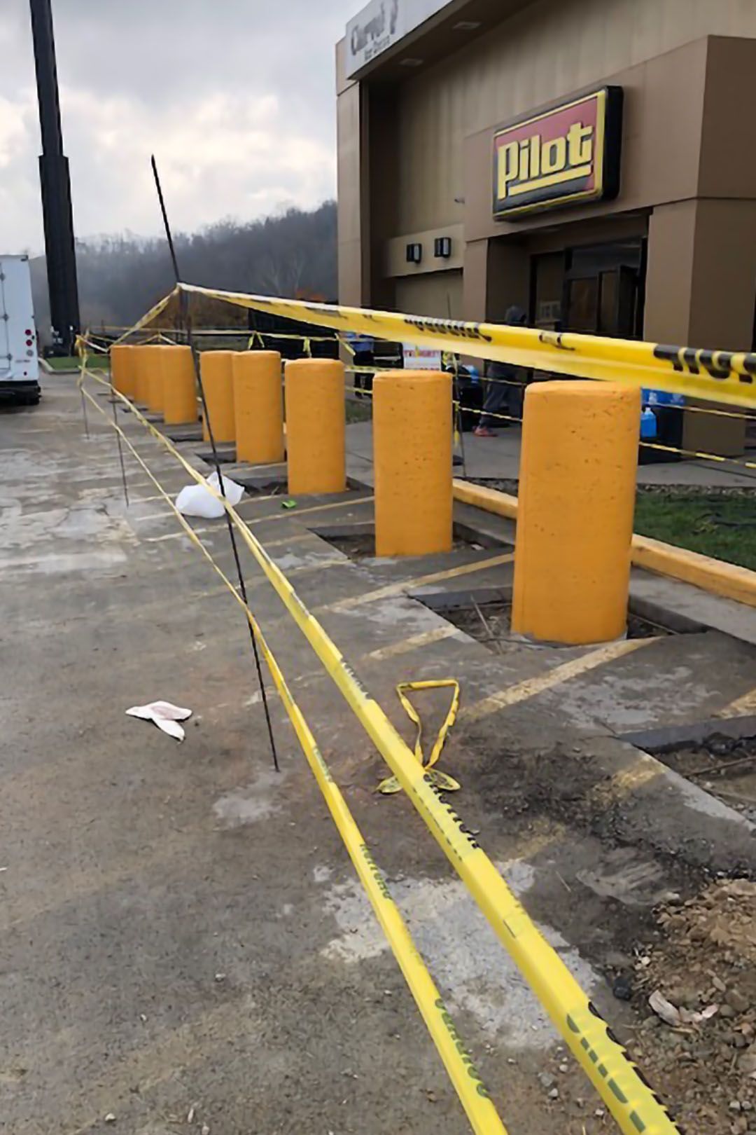 a row of yellow poles are lined up in front of a building