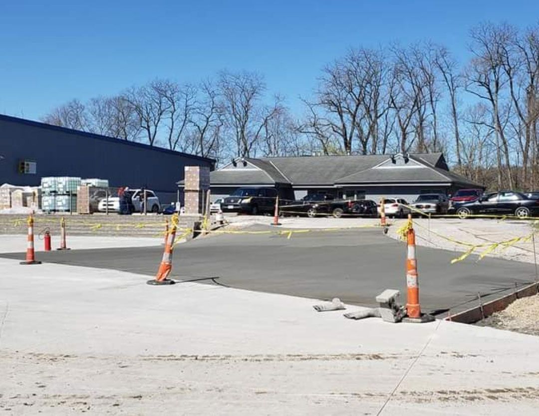 A parking lot is being built in front of a building.