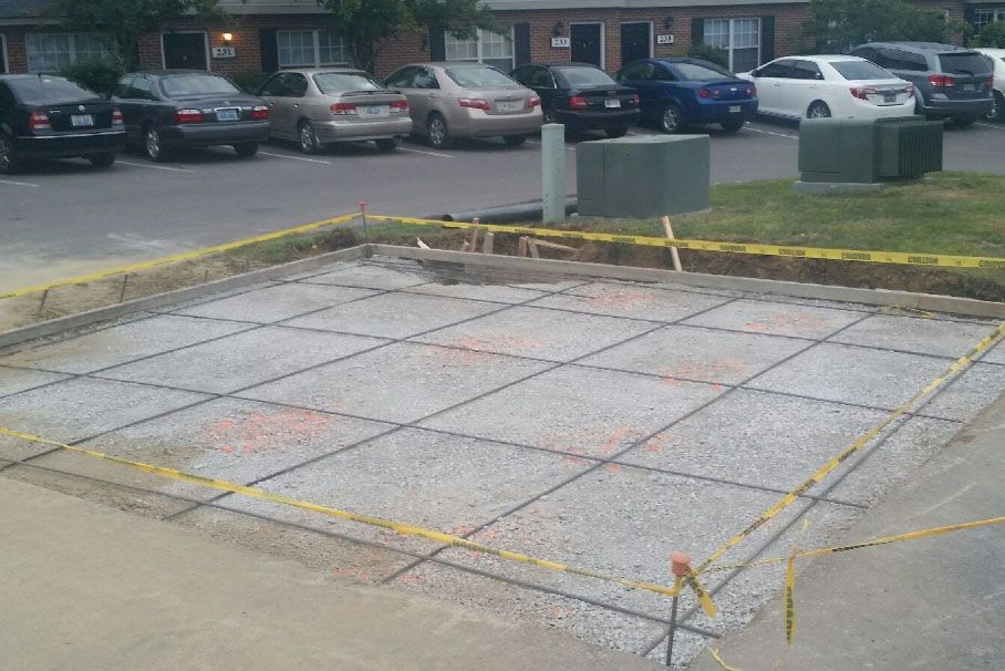 a parking lot with cars parked in front of a building under construction