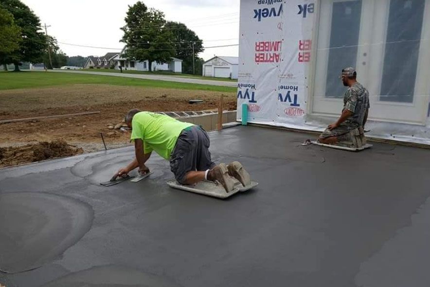 two men working on a concrete floor
