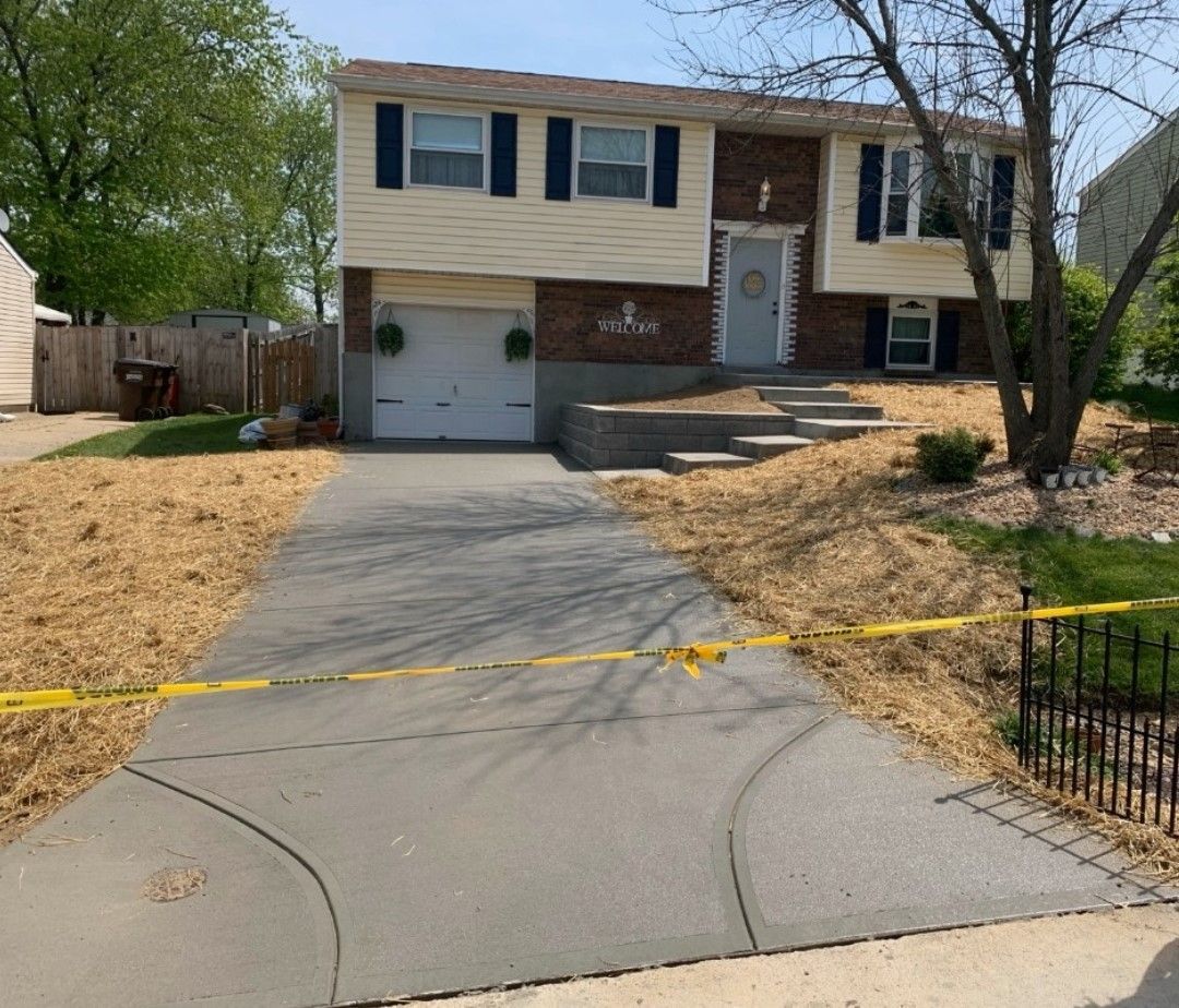 a house with a concrete driveway leading to it