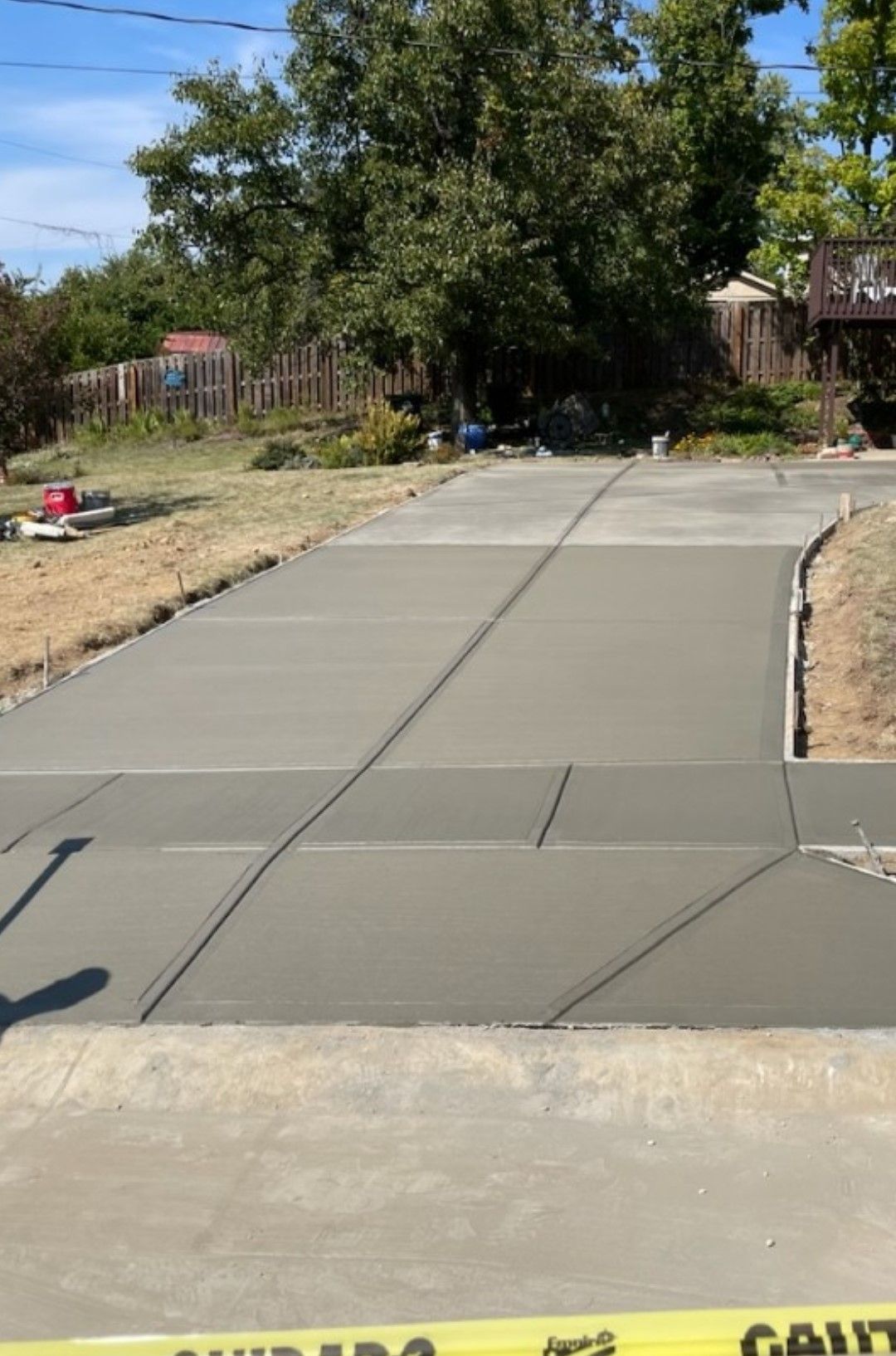 a concrete driveway is being built in front of a house