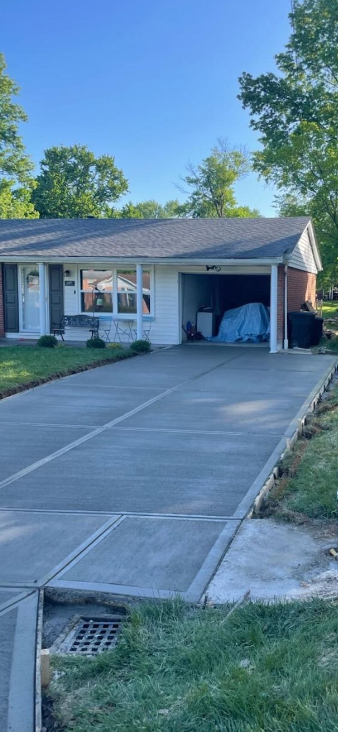 a house with a concrete driveway leading to it and a garage
