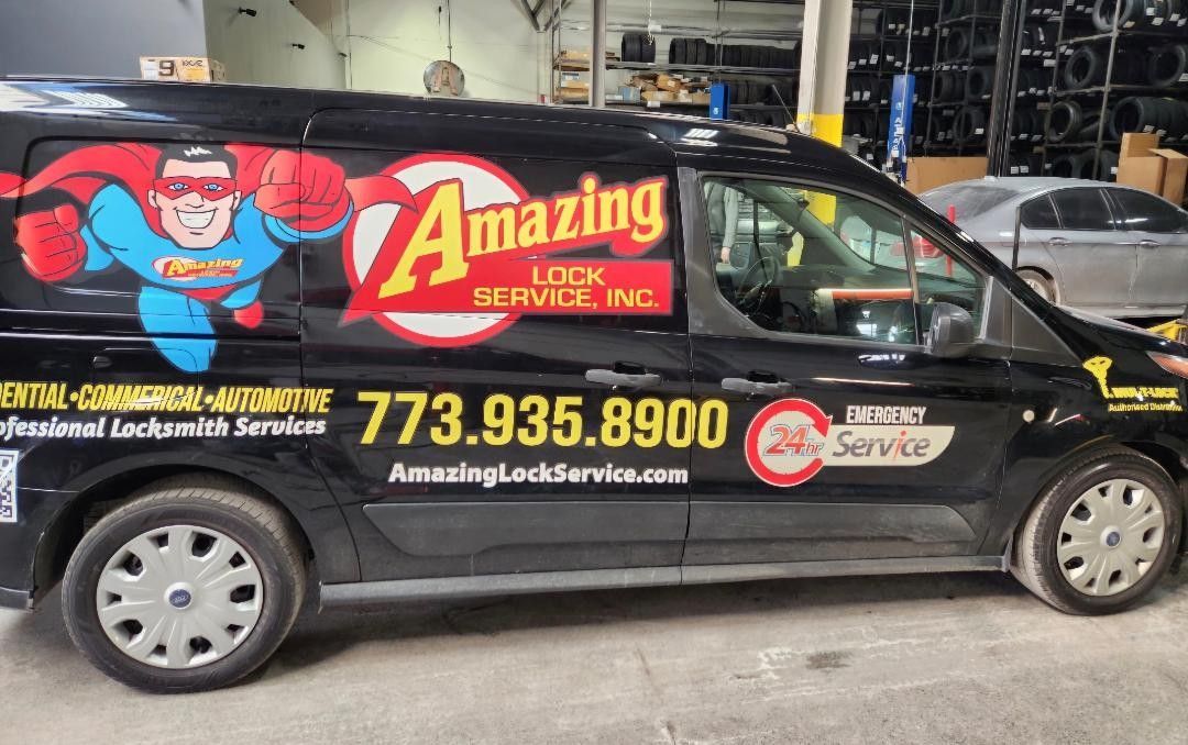 Black van with  Amazing Lock Service logo and phone number; superhero graphic.