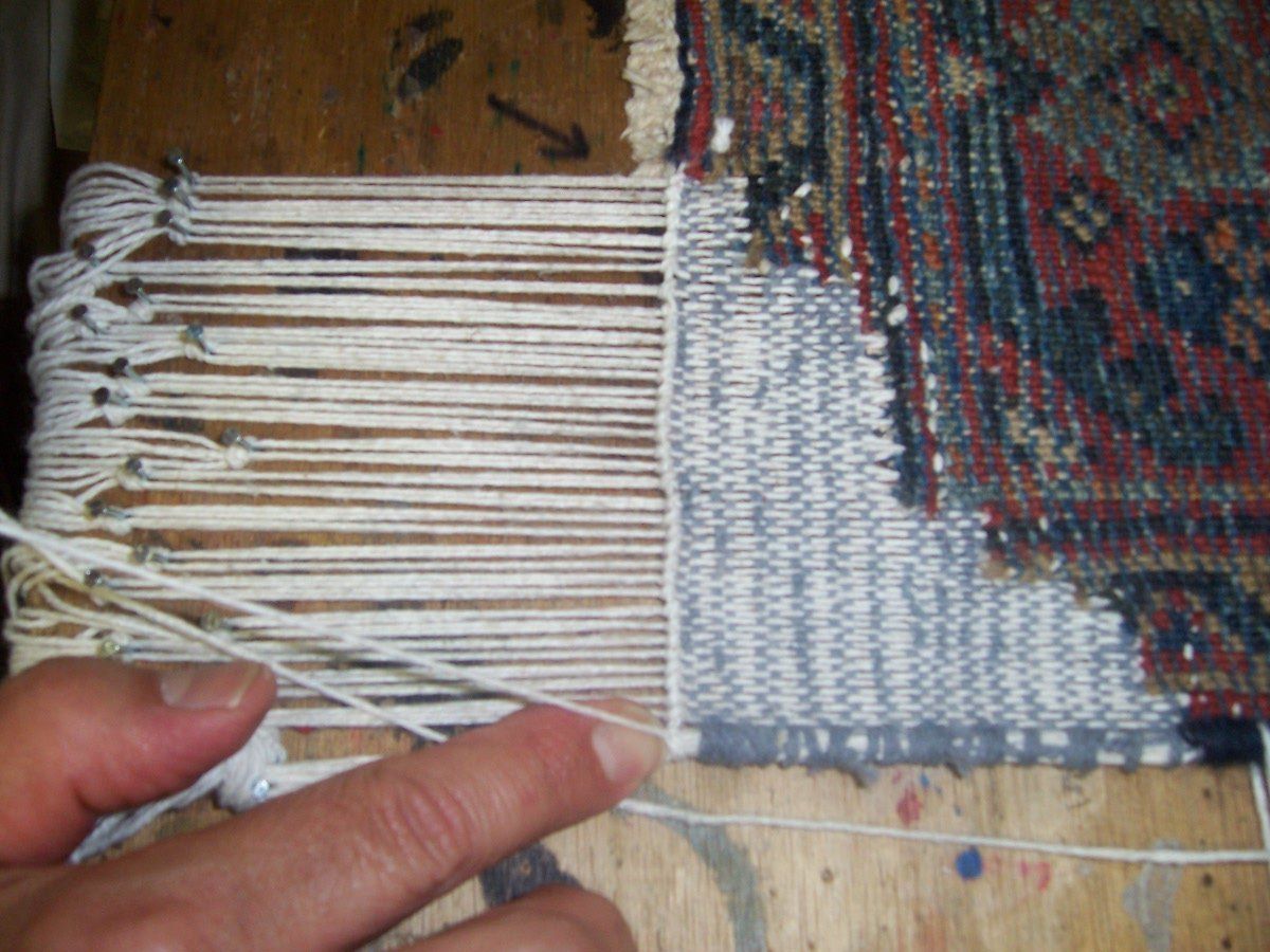 hand doing kilim weaving