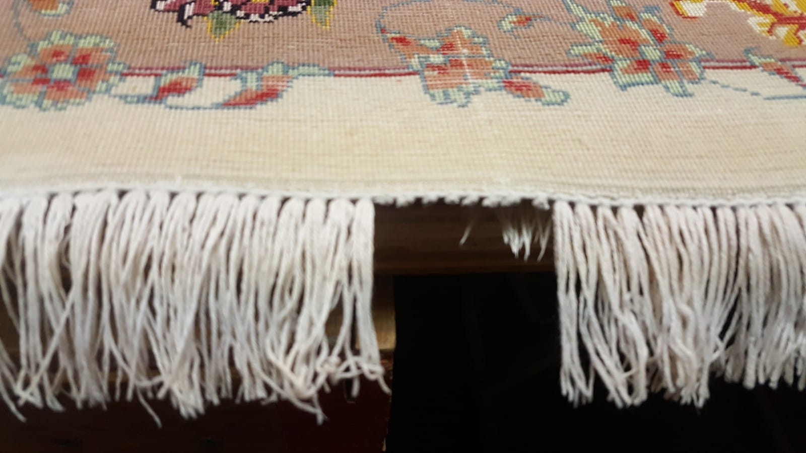 Rug fringe being repaired
